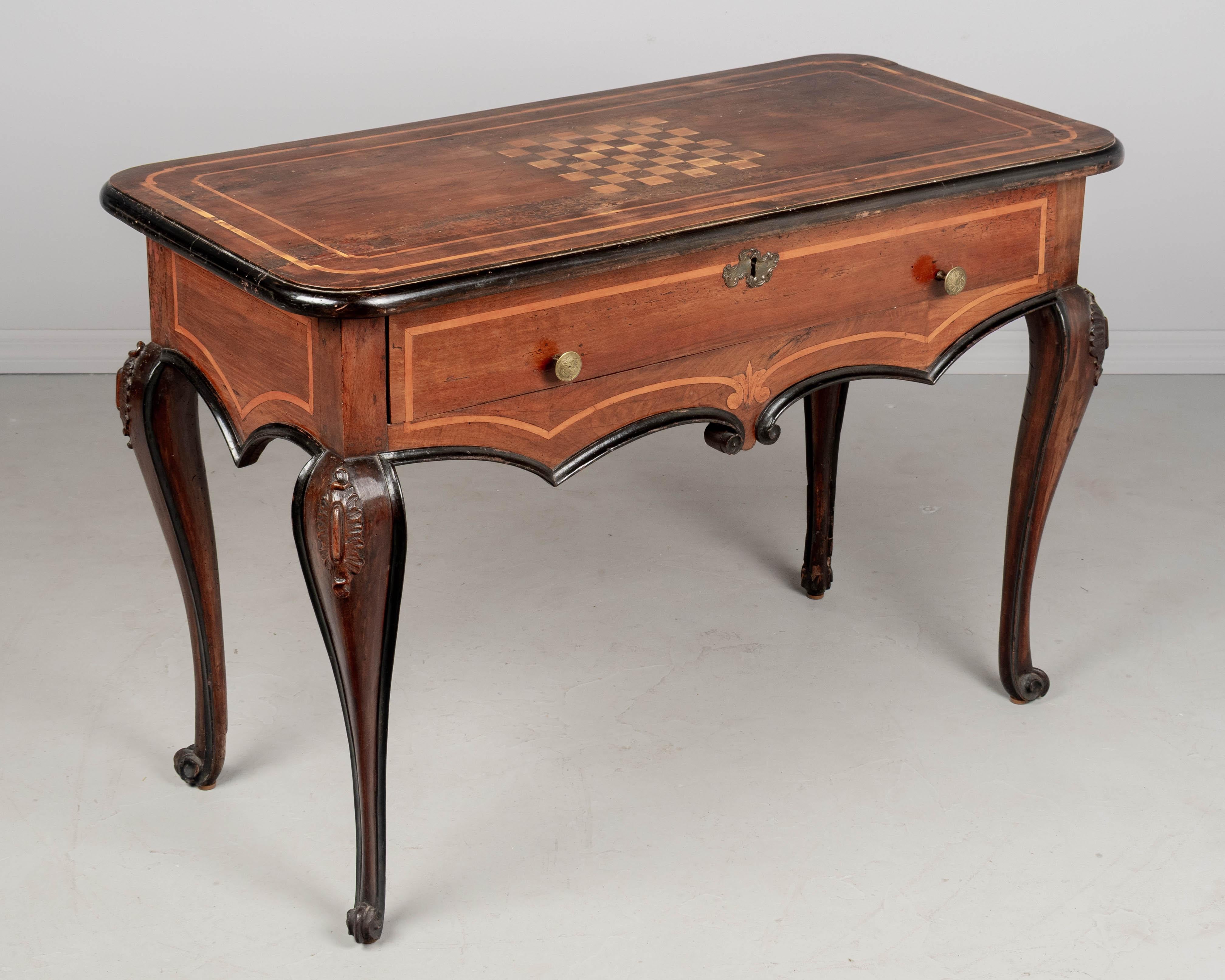 An 18th century Italian Louis XV style center table or console from Torino. Bold design made from thick planks of solid walnut with ebonized trim and finished an all for sides so that it may be free-floated in a room. Curved cabriole legs with