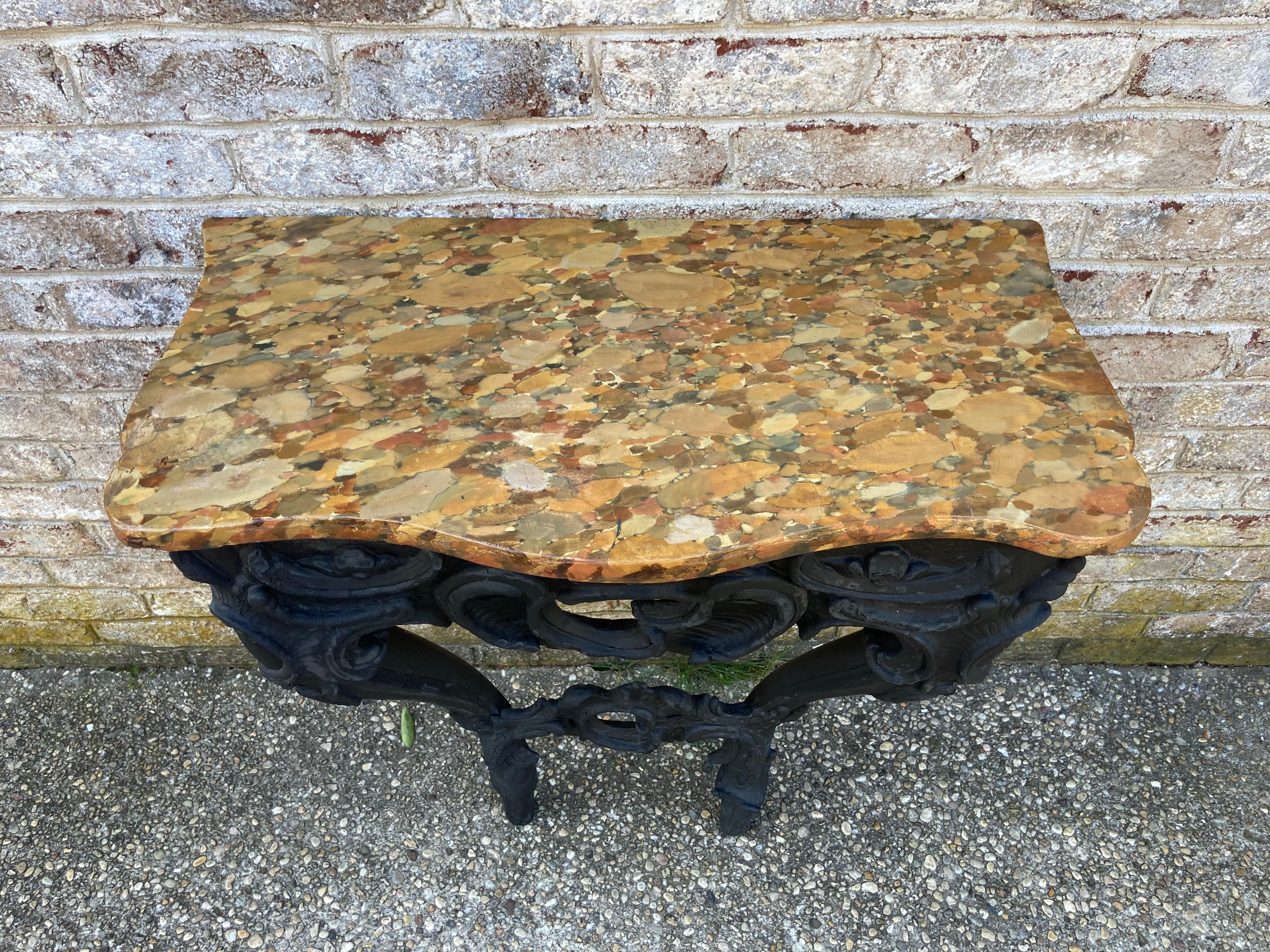 Wall mounted console with a faux marble painted top. console base itself has recently been burned and painted black to resemble Shou Sugi Ban. the original carved base is 18th Century Italian. the painted faux marble top is early 20th century.