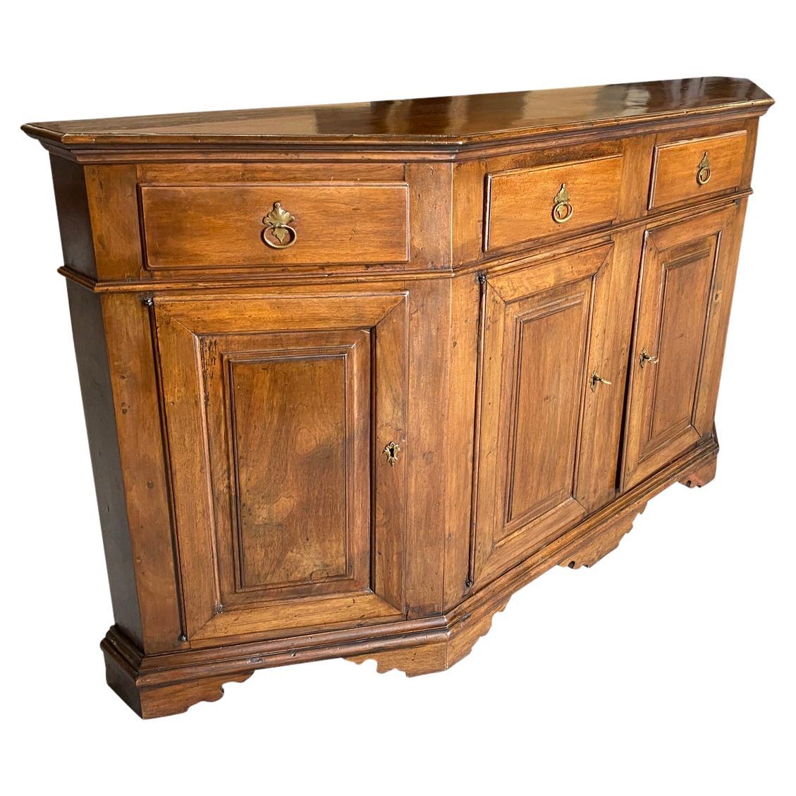 A very handsome 18th century Credenza from the Veneto region of Italy.  Beautifully constructed from walnut in the Scantonata form with a molded edge top above a conforming case housing two diagonal opening drawers and two central drawers.  The