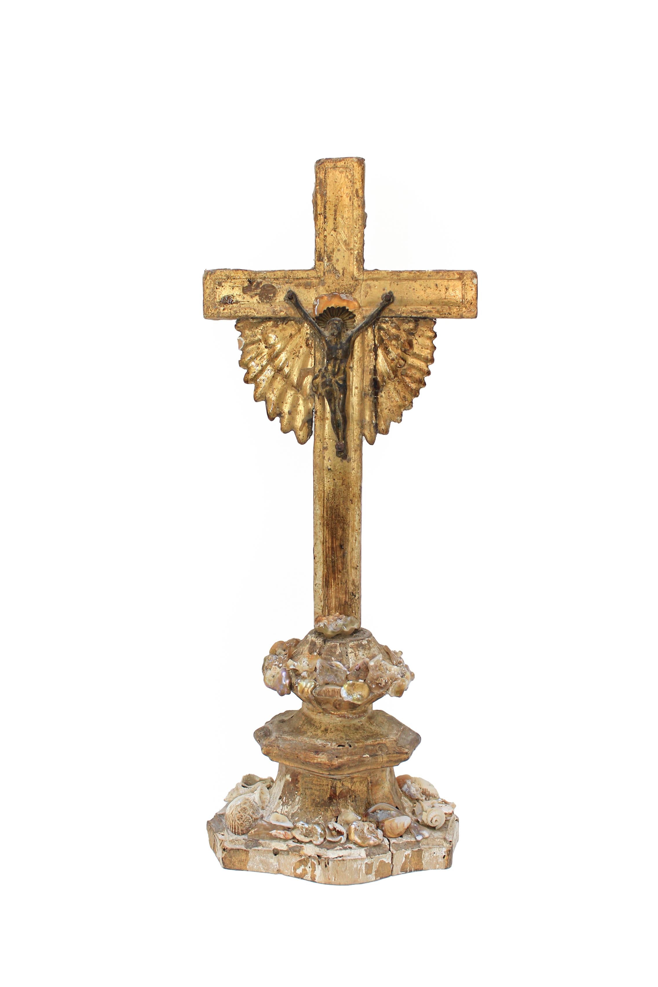 18th century Italian gold leaf crucifix with a bronze figure of Christ and adorned with baroque pearls, polished minerals, and fossil shells. The crucifix originally came from a church in Tuscany. 

The piece is put together by Jean O'Reilly