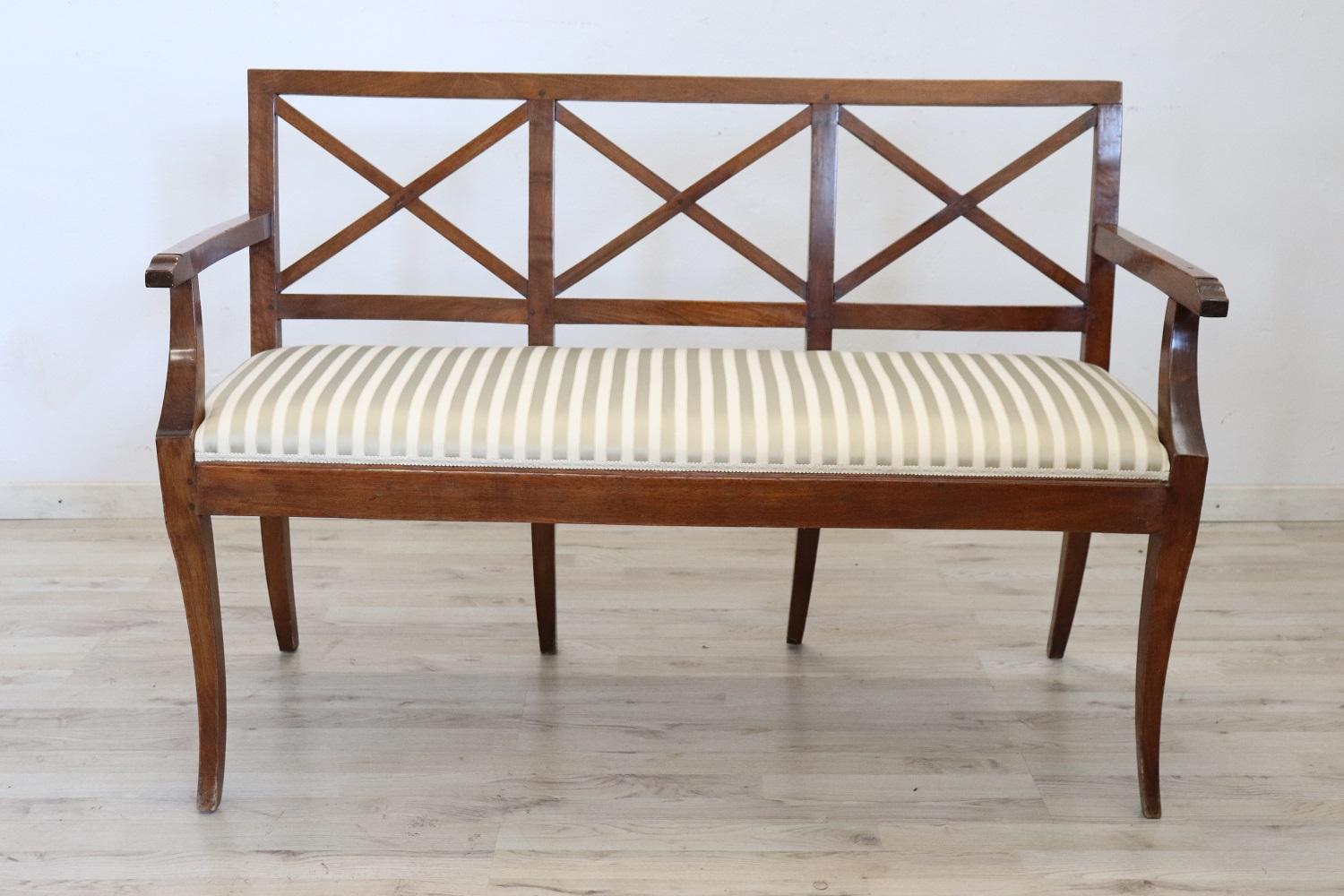 Antique bench 1790s in full directoire era. The bench is made of solid walnut wood. Refined seat in silk. Excellent antique good conditions of the wood, some signs of wear in the silk. It is an adorable bench due to its small size and is perfect in