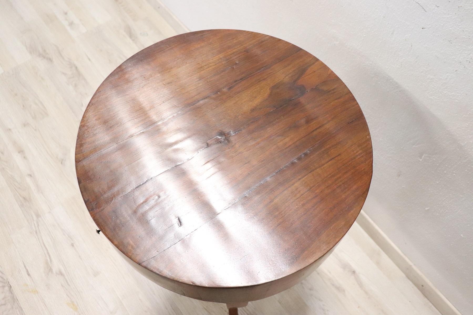Rare and fine quality Italian Directoire 18th century side table or pedestal table. The round table is made of fine walnut wood with a beautiful patina. Elegant slender and wavy legs. On the front a comfortable drawer. Really delicious table. True