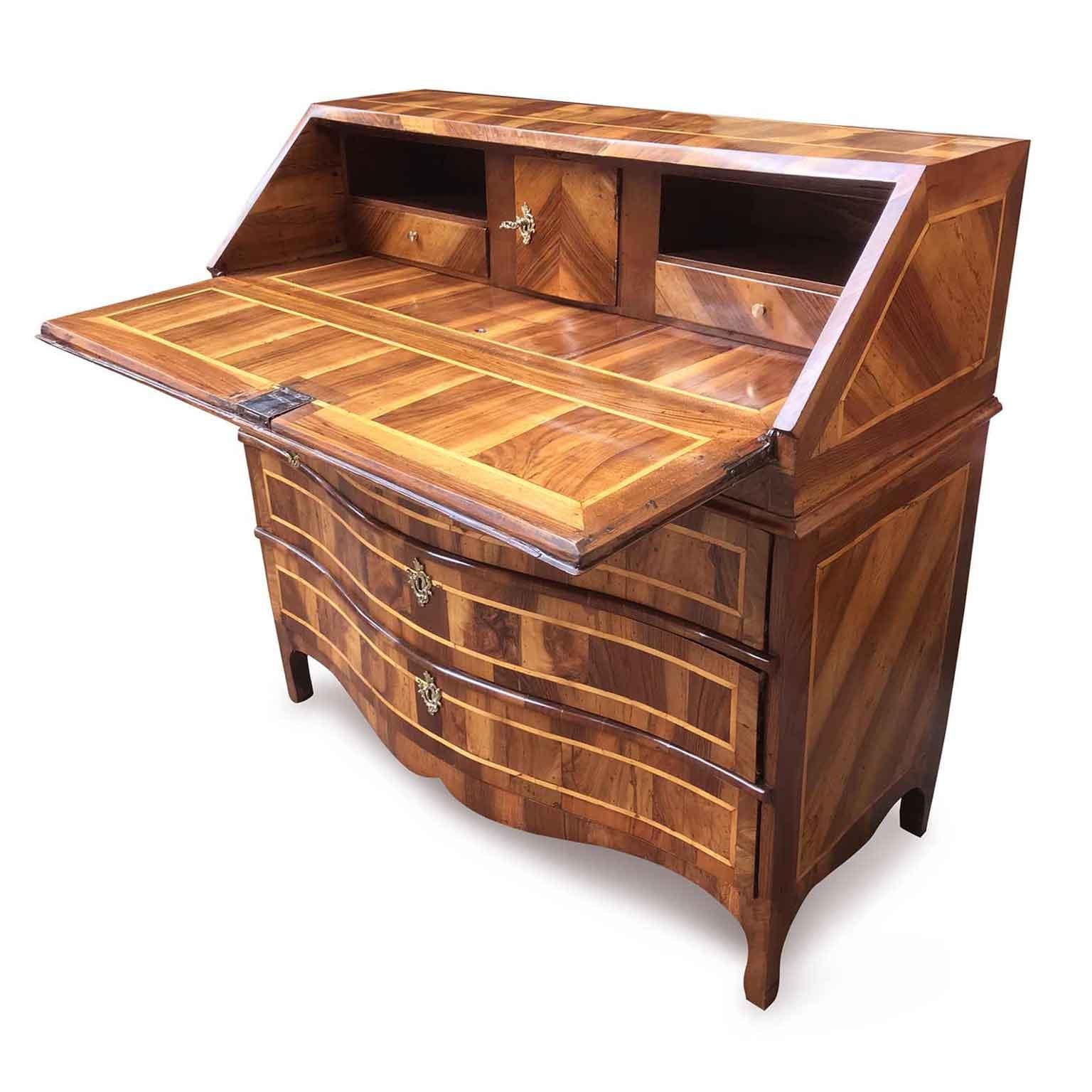 An Italian bureau with flap dating back to the second half of 18th century. A slightly curved front, three deep drawers and a fall-front opening to reveal an interior with two small drawers, compartments one small door and hiding secrets, see