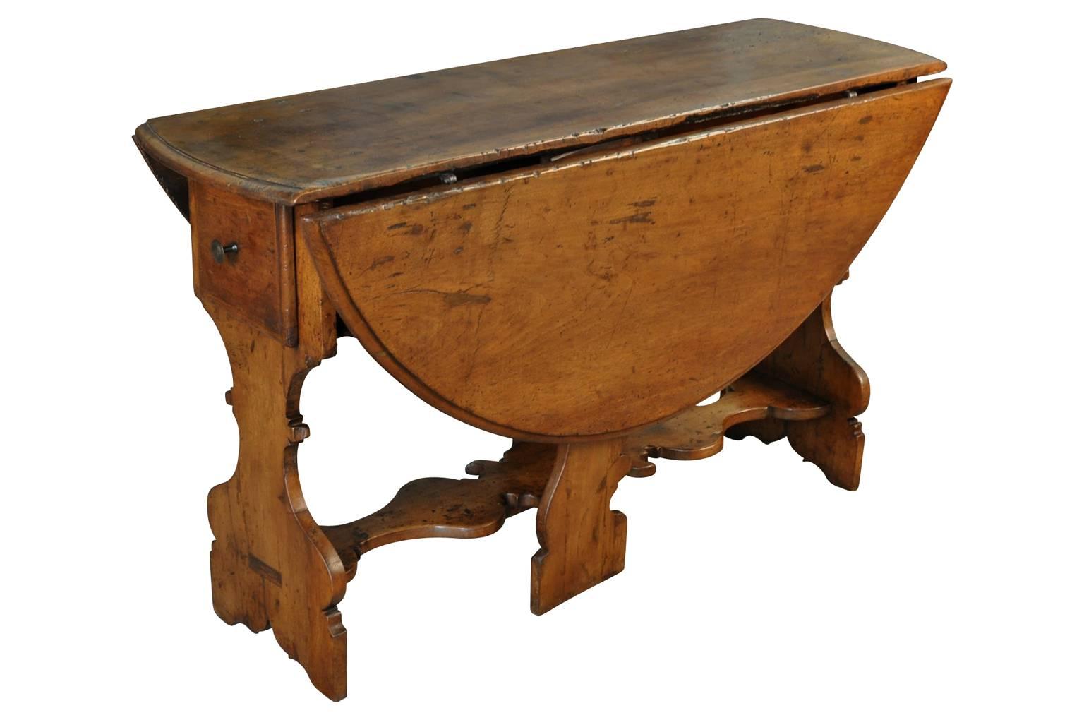 A very lovely Italian 18th century drop leaf two drawer center table from the Lombardi region of Italy. Masterly constructed from walnut. Fabulous patina, rich and luminous. Also wonderful as small dining or kitchen table as well.