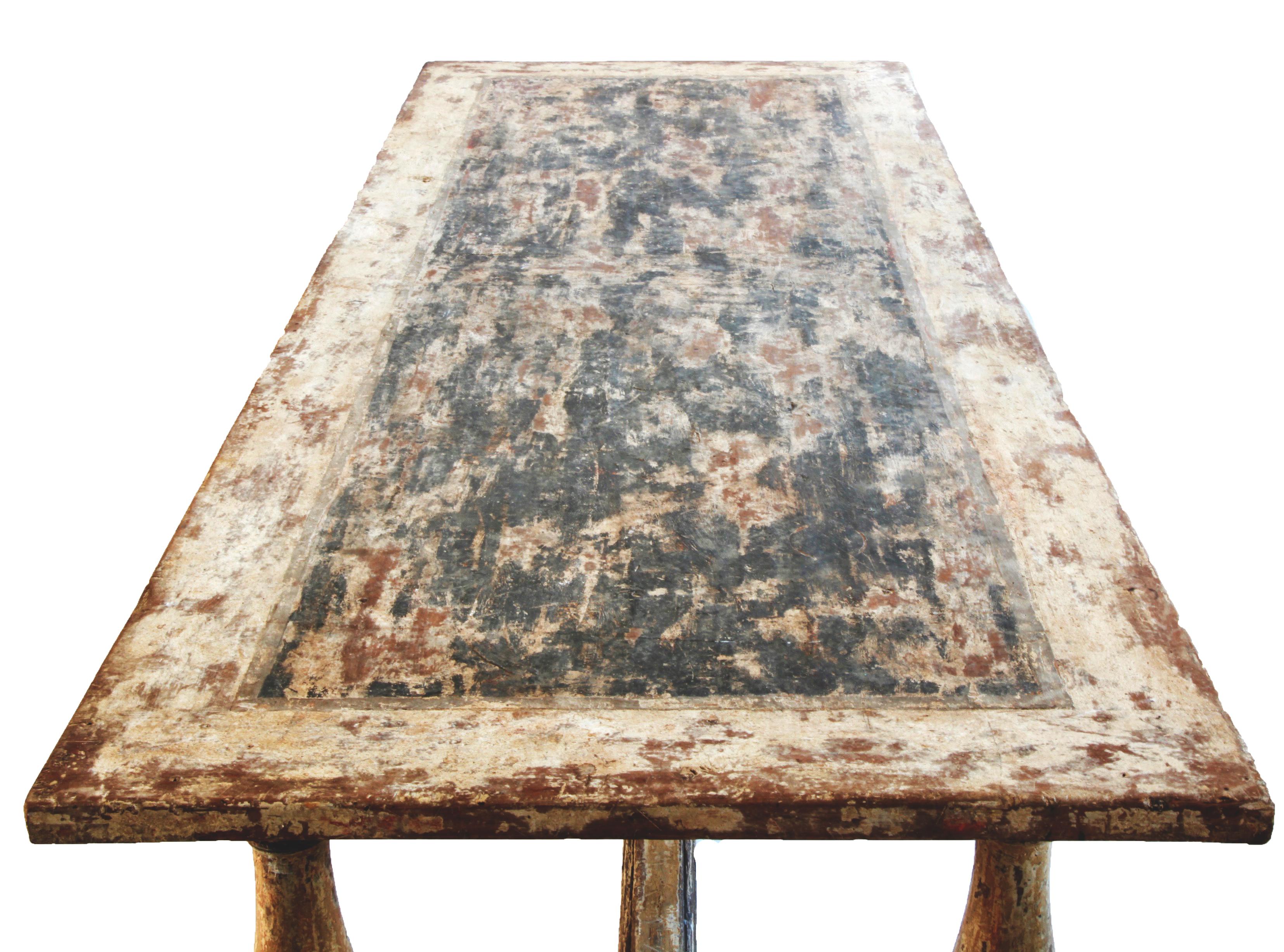 This robust and spirited, late 18th century rustic farmhouse table from Sicily, Italy is made in solid pine wood and has an apron and turned legs embellished with simple mouldings and sits on a base frame 'H' stretcher. The table has its authentic