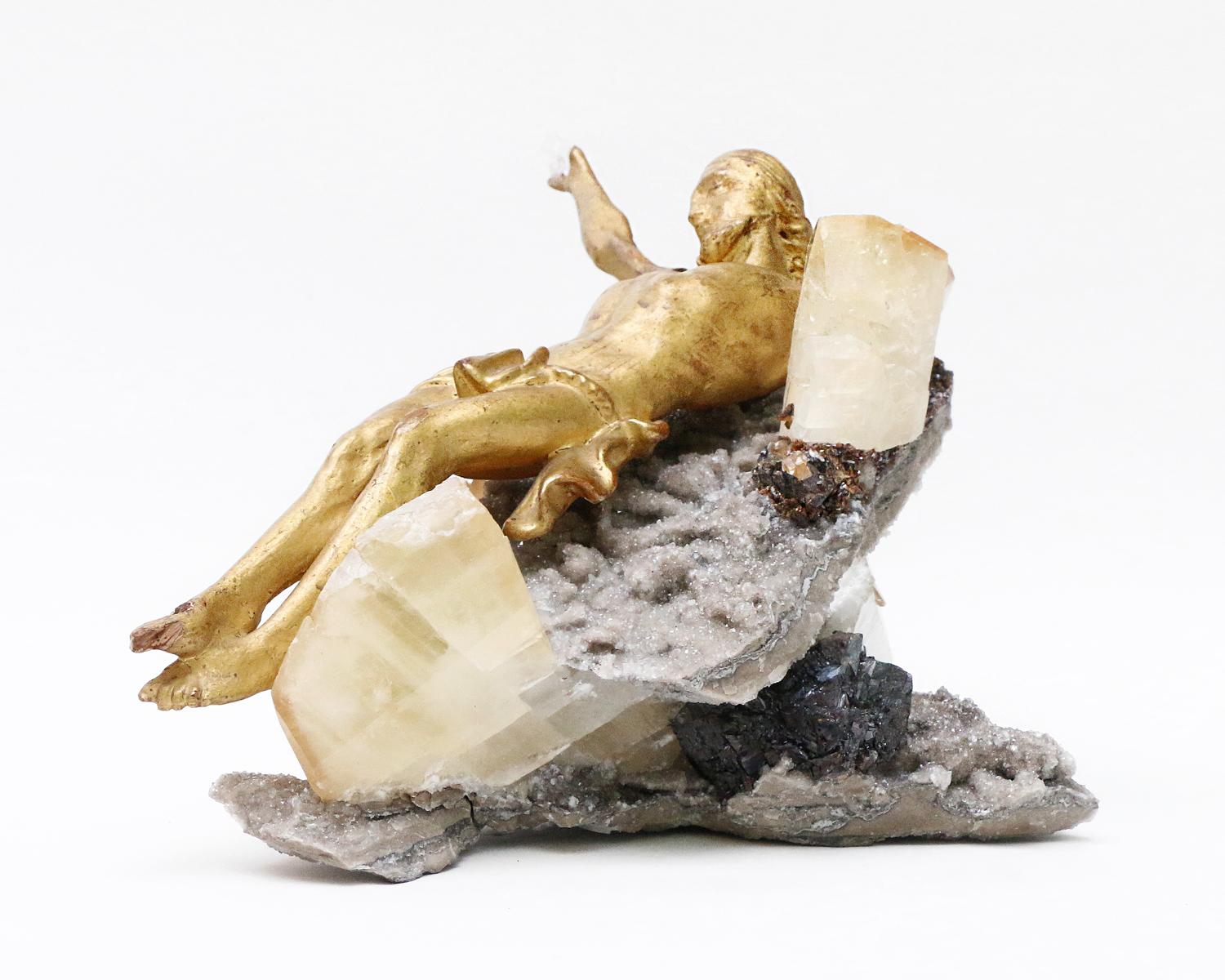 Sculptural 18th century Italian gold leaf wood fragment figure of Christ (Florence) on calcite crystal cluster in matrix. 

The calcite crystal cluster is from Elmwood Mine, Tennessee. It is an example of the world's finest crystallized calcite.