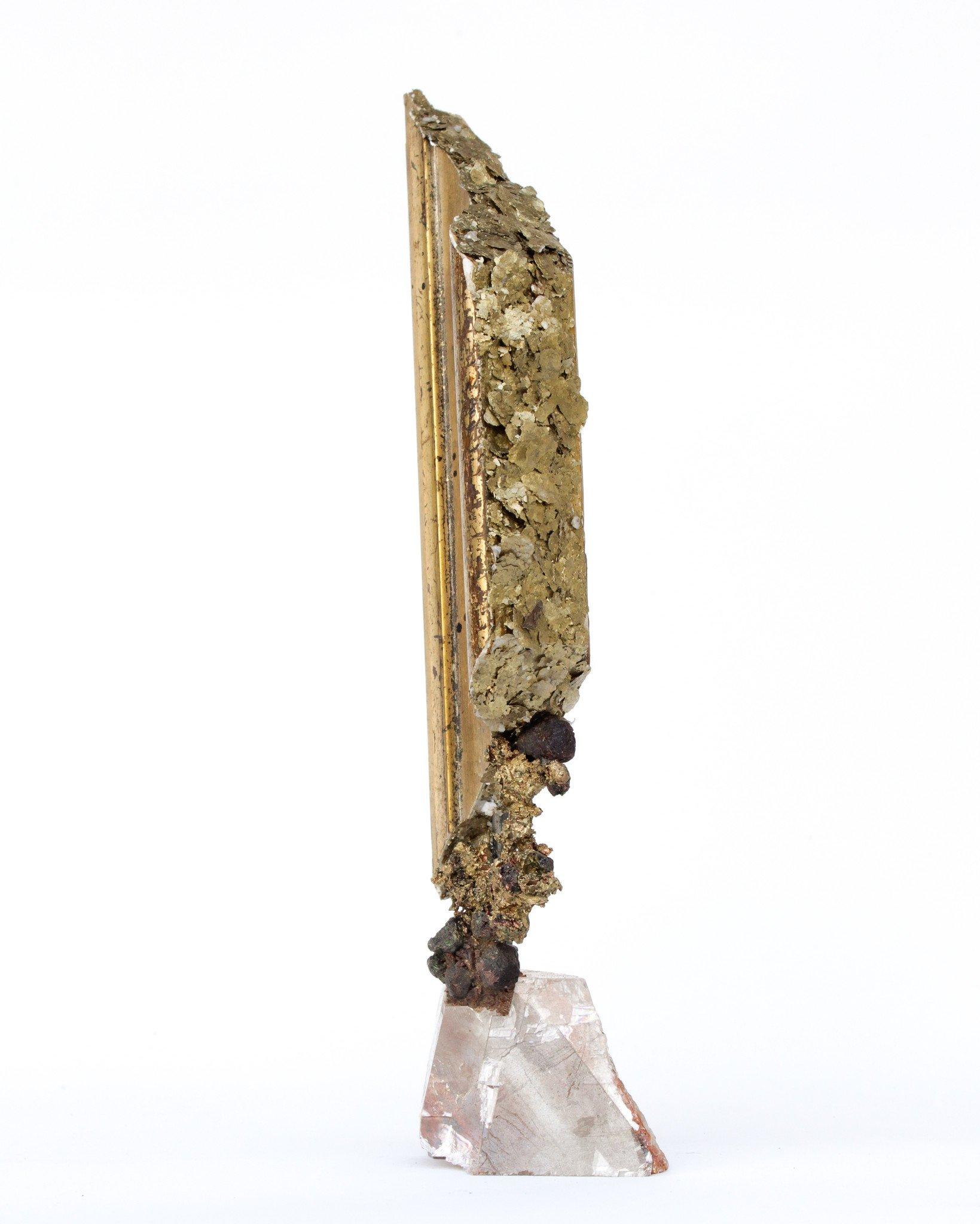 18th century Italian fragment decorated with natural forming copper, garnets, and gold mica on an optical calcite base.

The Italian fragment originally came from a piece in a church in Tuscany. It is then mounted onto the optical calcite base