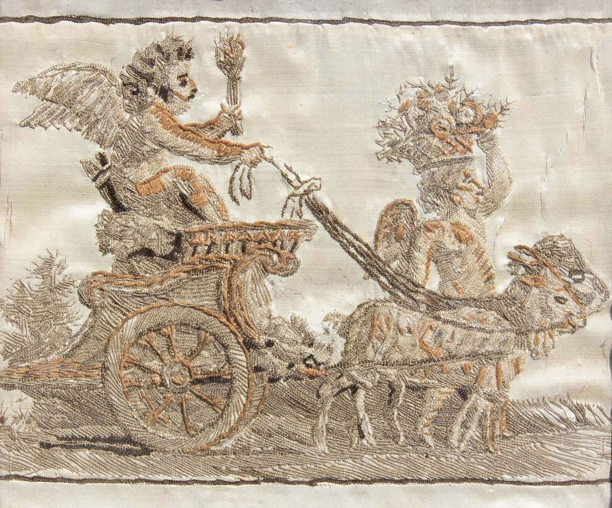 18th century Italian silk embroidery of cherub riding a chariot. In a carved wood and gesso 18th century Italian frame. Renaissance style.