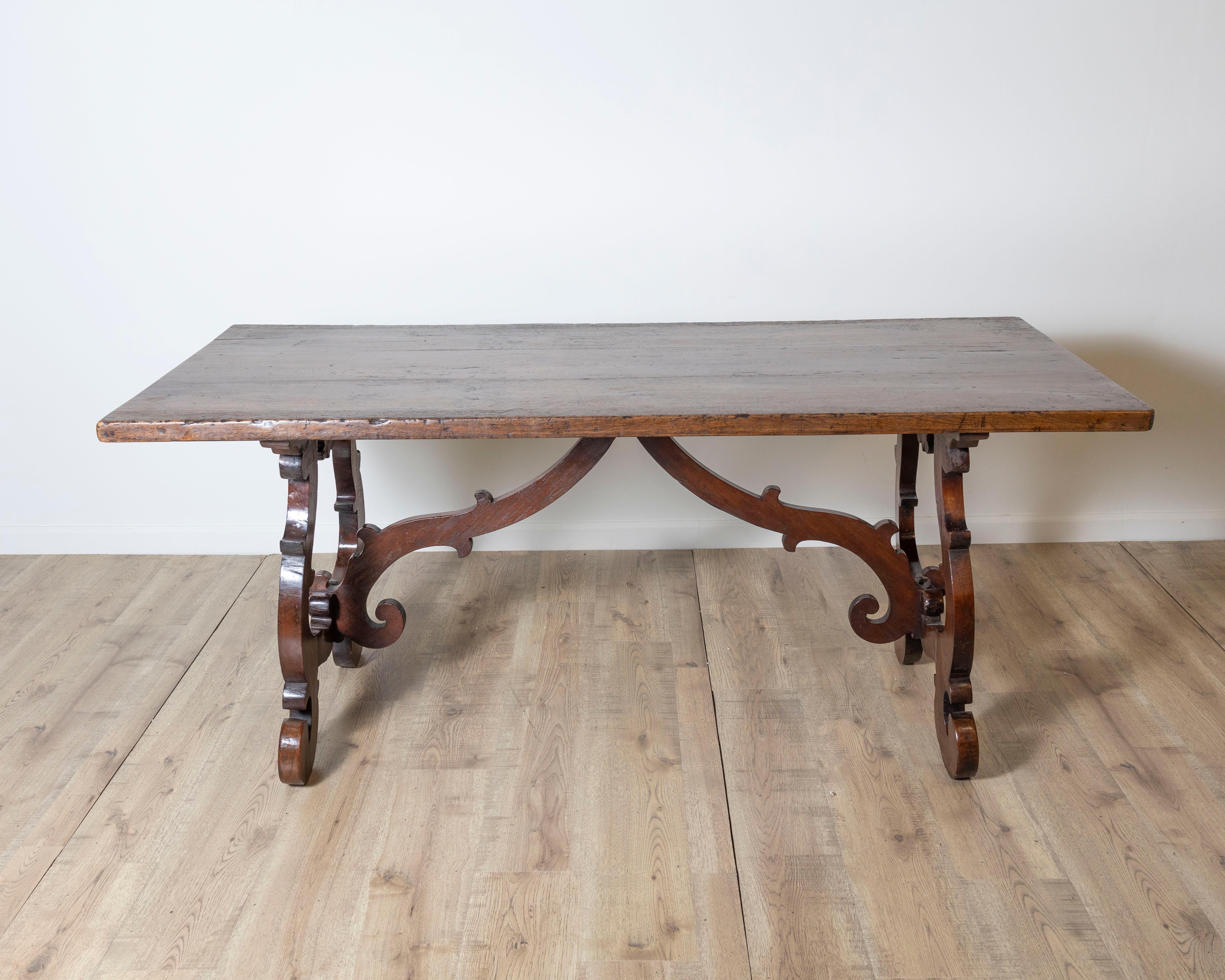 An exceptional 18th-century Italian Fratino table, handcrafted in solid walnut with beautifully aged patina and distinctive architectural presence. This elegant piece exemplifies the Italian Baroque tradition, featuring a thick rectangular top with