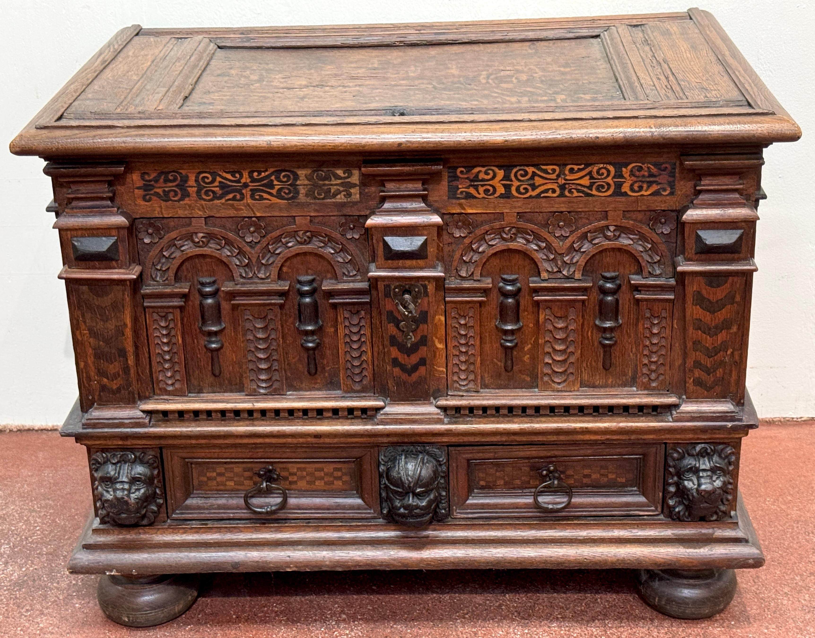 18th Century Italian or French Renaissance Revival Strongbox Chest with Inlay and Lion Masks

A richly detailed 18th-century Italian or French Renaissance Revival strongbox or coffer, masterfully crafted in solid oak with contrasting marquetry and