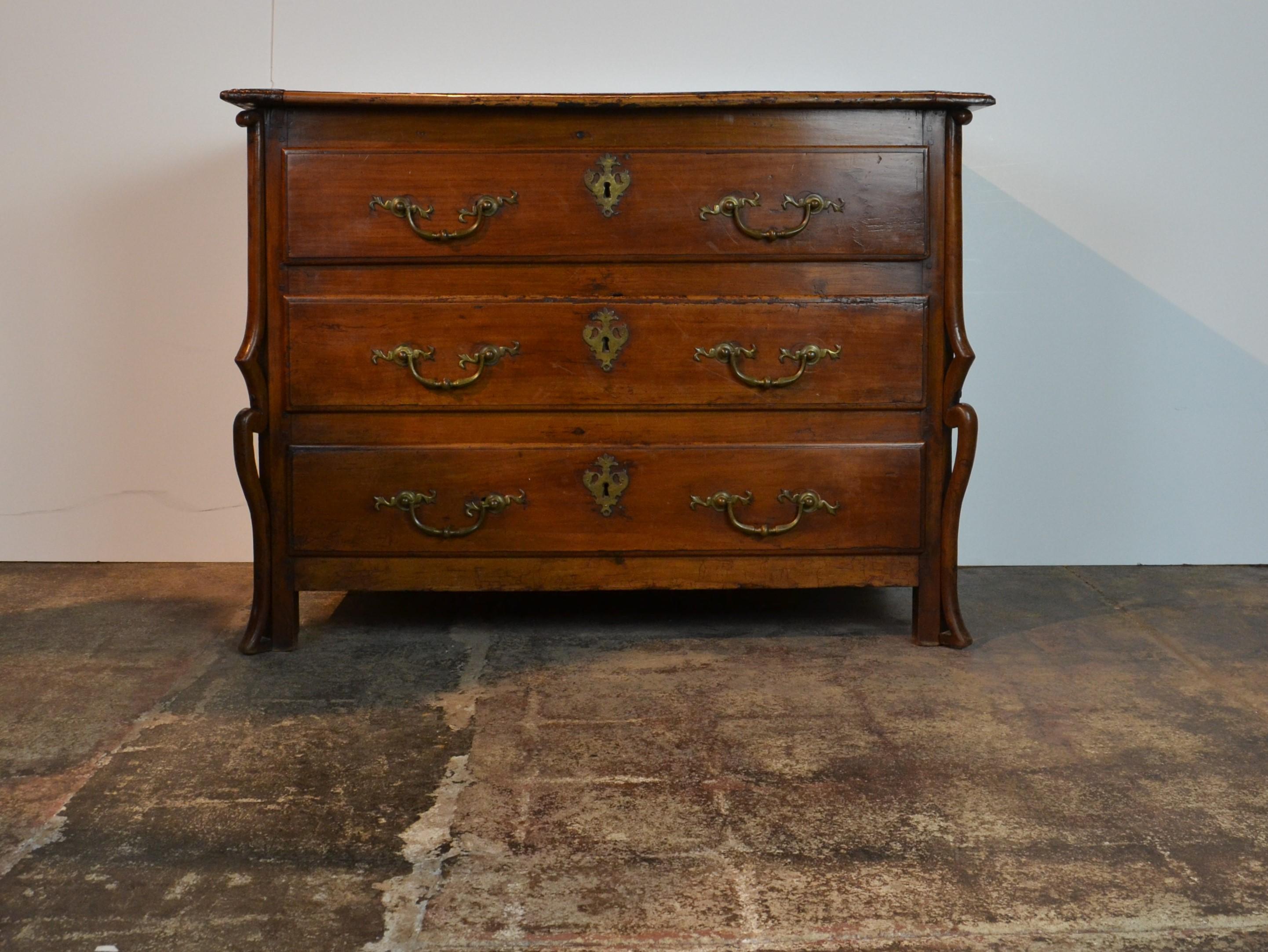 A very rare Italian chest of 3 drawers in fruitwood. Unusual front leg and foot embellishments, circa 1750. Heavy brass drop handles. Early brass keyhole escutcheons. Overall, a really 