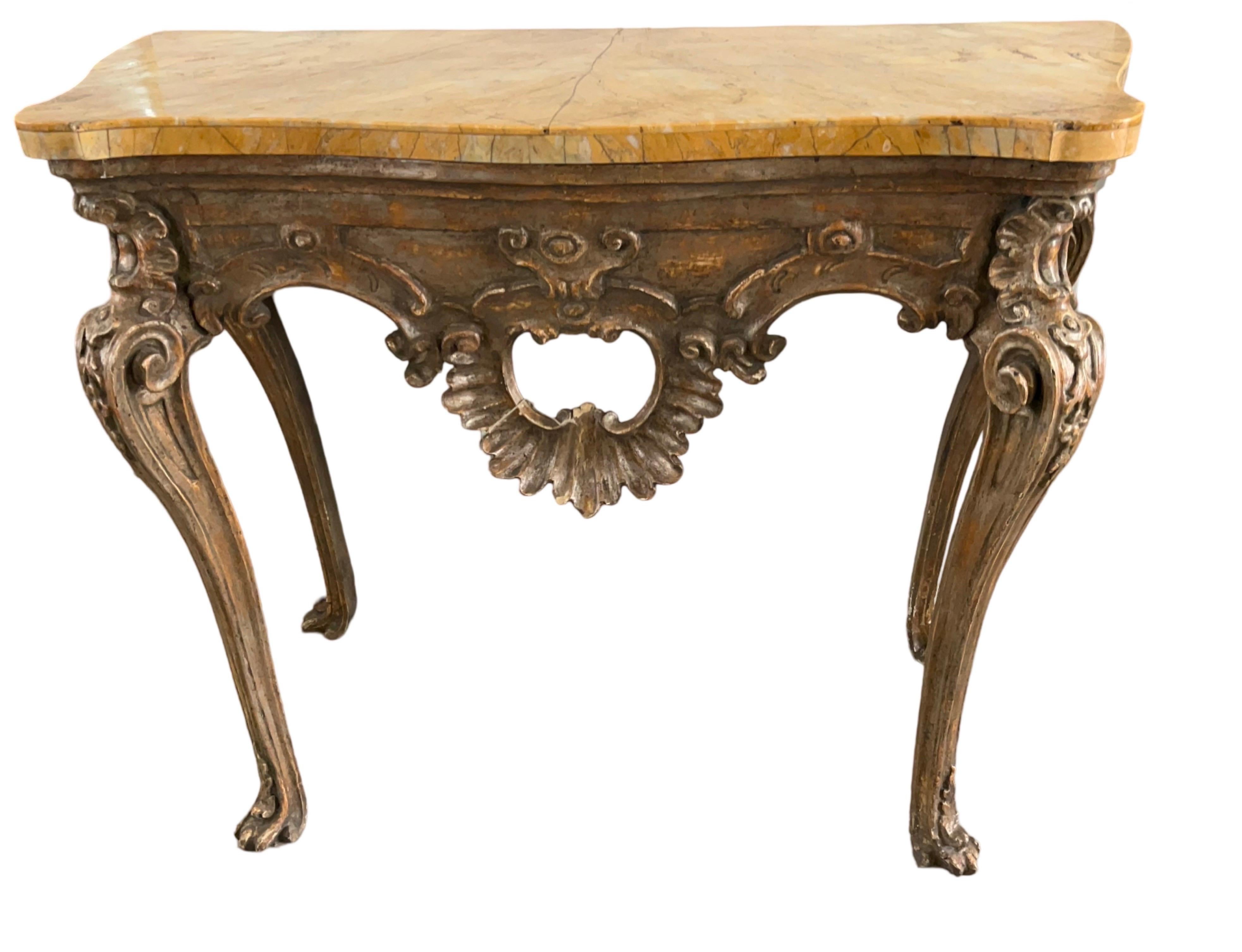 Genovese console table hand-made in Italy in the mid 1700s using poplar for the base and Siena marble for the top. The console table sits on the original hand-carved cabriole legs that end with paw feet. The marble and the base both have a