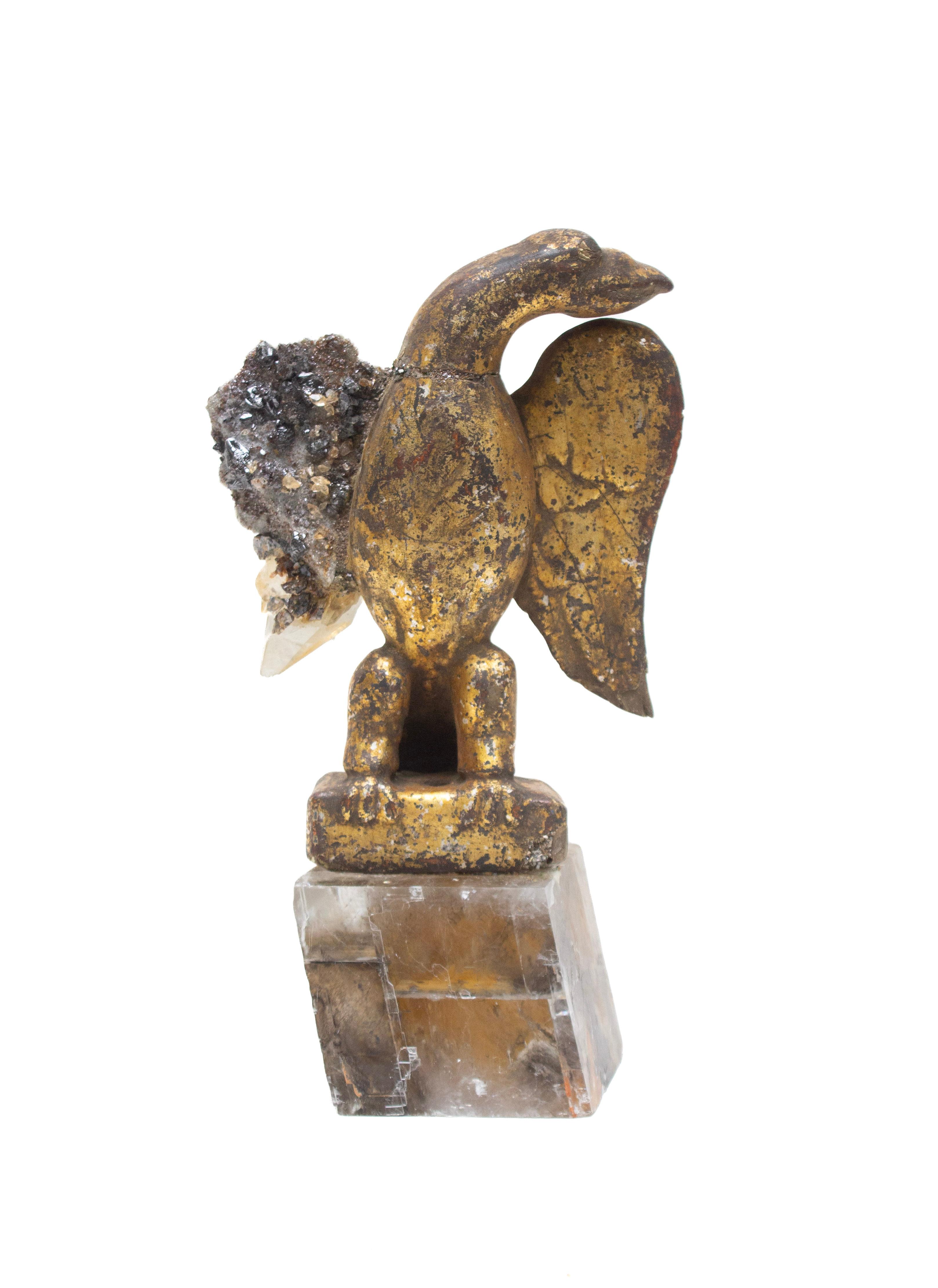 18th century Italian hand-carved and gilded eagle on a cut phantom calcite crystal base. The missing wing of the eagle has been replicated with a rare coordinating calcite crystal cluster in a matrix of sphalerite.

This fragment artifact is