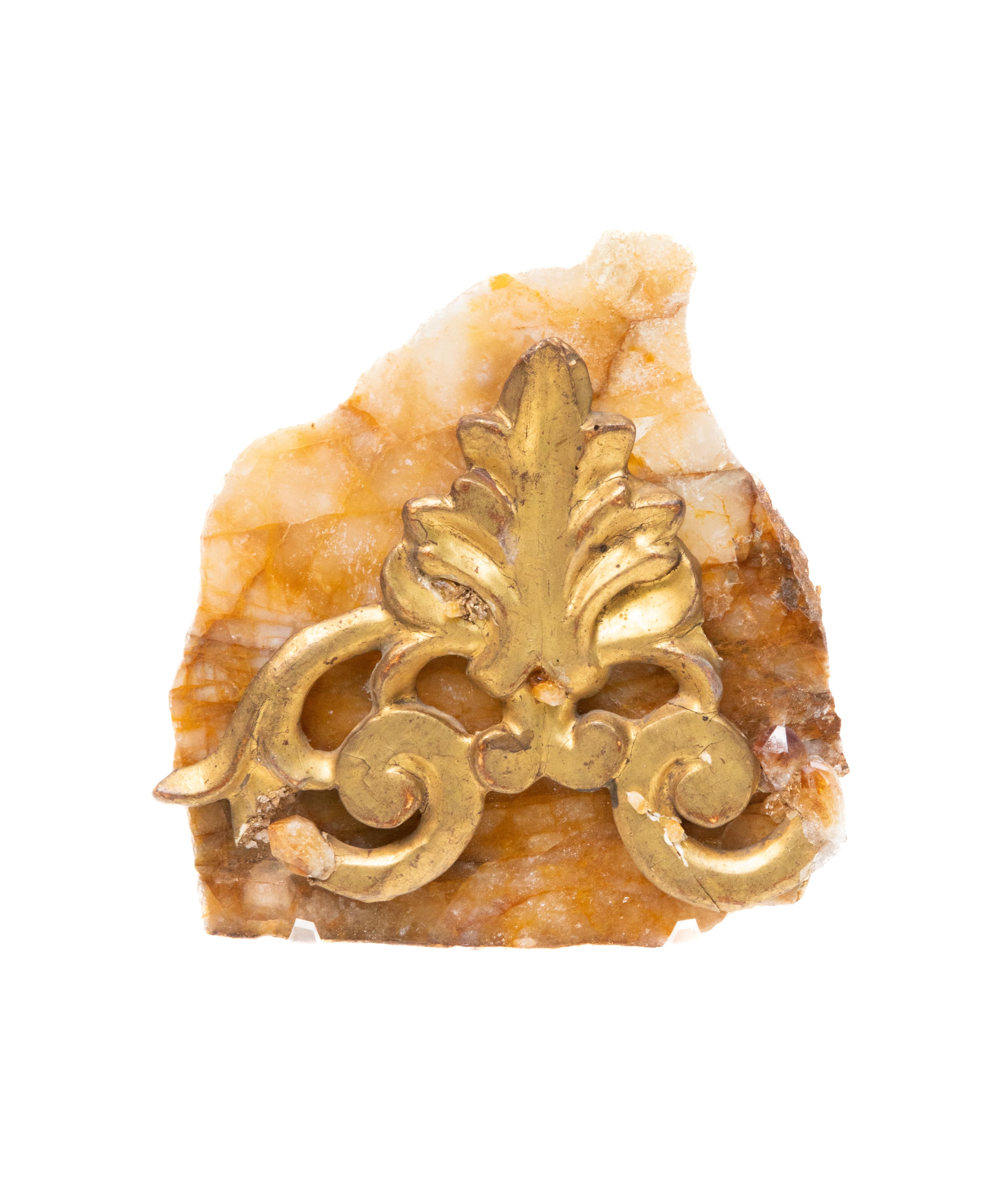 18th century Italian gilded fragment mounted on a golden, polished hematoid slab and adorned with tangerine quartz crystals.

The piece is put together by Jean O'Reilly Barlow, the artist and creative director of Interi. The date of manufacture