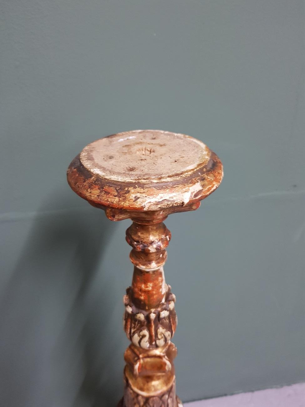 18th century Italian wooden church candlestick with original gilding which has unleashed several places, the candle holder on the top is missing.

The measurements are,
Depth 15 cm/ 5.9 inch.
Width 17.5 cm/ 6.8 inch.
Height 69 cm/ 27.1 inch.