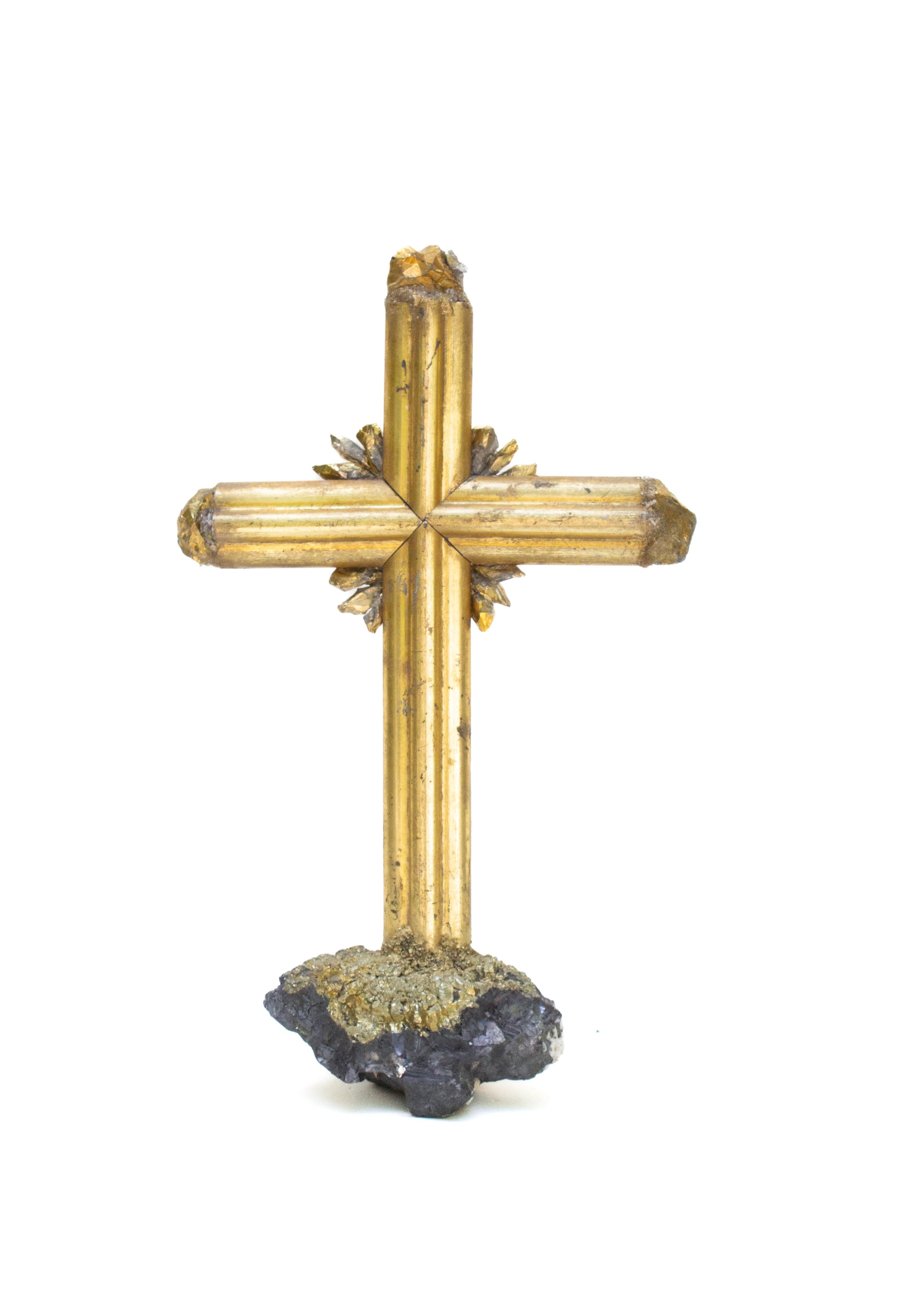 Sculptural 18th century Italian gilded cross mounted on hematite with natural-forming pyrite. Gold-plated crystals adorn each point of the cross. Gold-plated crystal points also surround the inside of the cross to replicate a halo or sunrays.

The