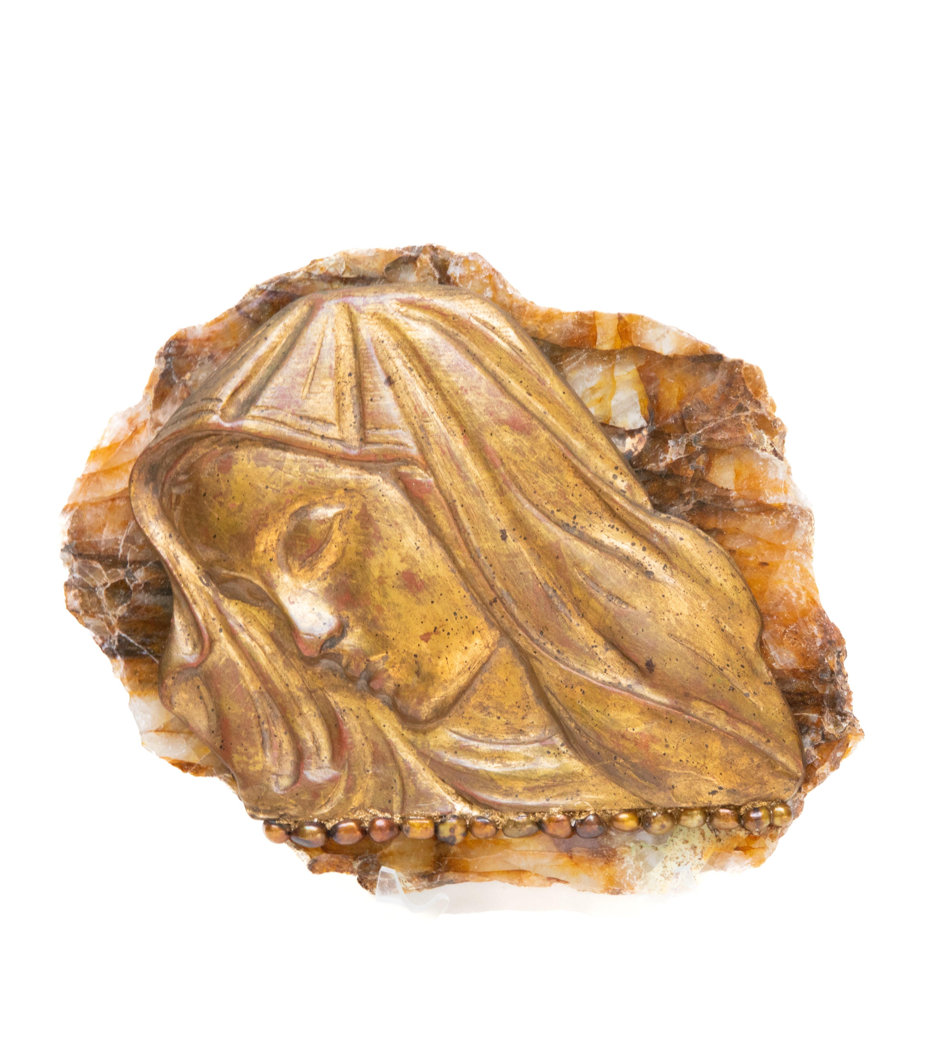 18th century Italian gilded hand-carved Madonna fragment mounted on a golden, polished hematoid slab and adorned with baroque pearls. The gilded fragment was originally part of a depiction of Mary in a historical Italian church. 
It is mounted on