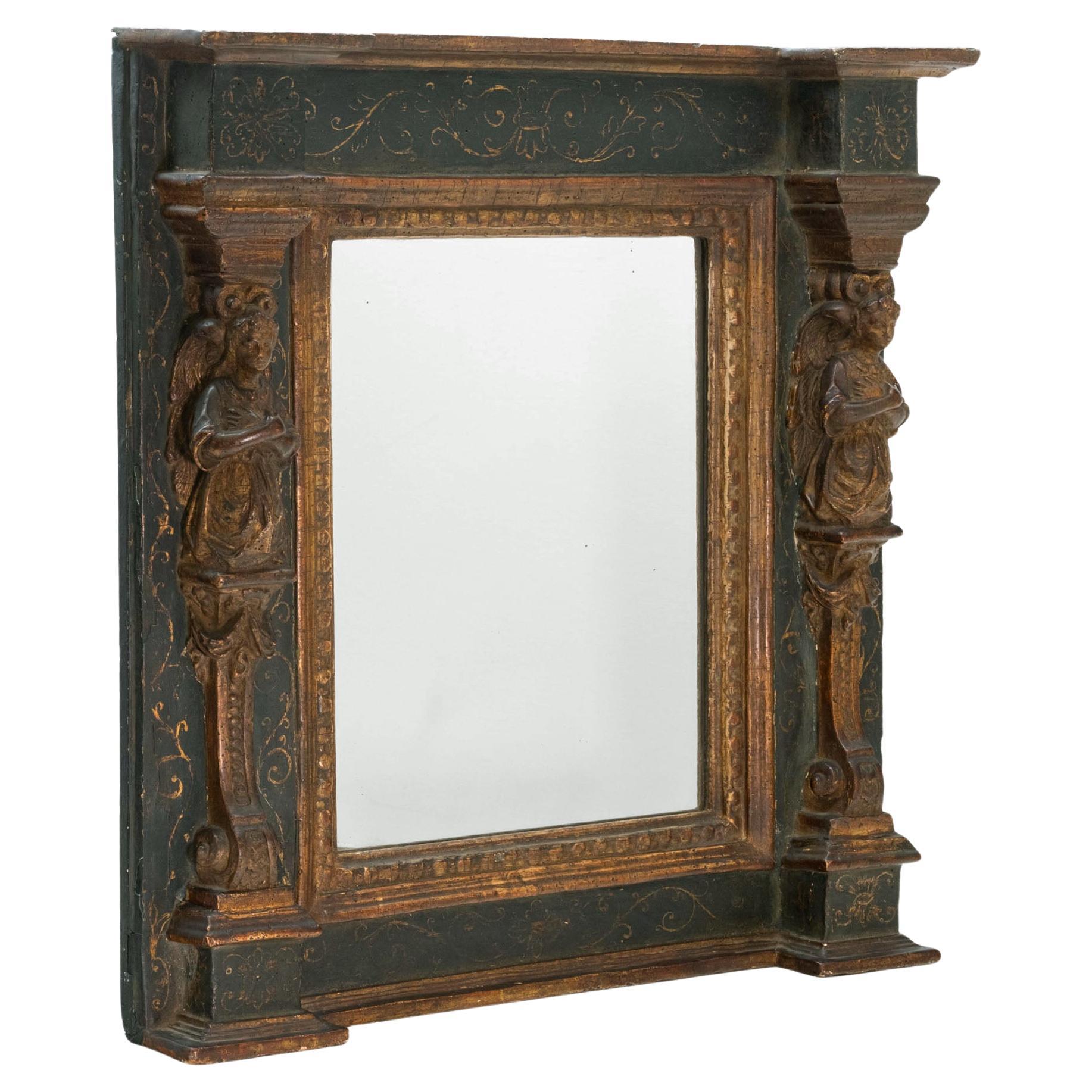 Espejo de pared italiano del siglo XVIII, pintado en azul de Prusia, de forma cuadrada, con columnas laterales cariátides de madera dorada tallada y cornisa moldurada invertida encima. Alrededor de 1780.

El acabado pintado en azul de Prusia muestra