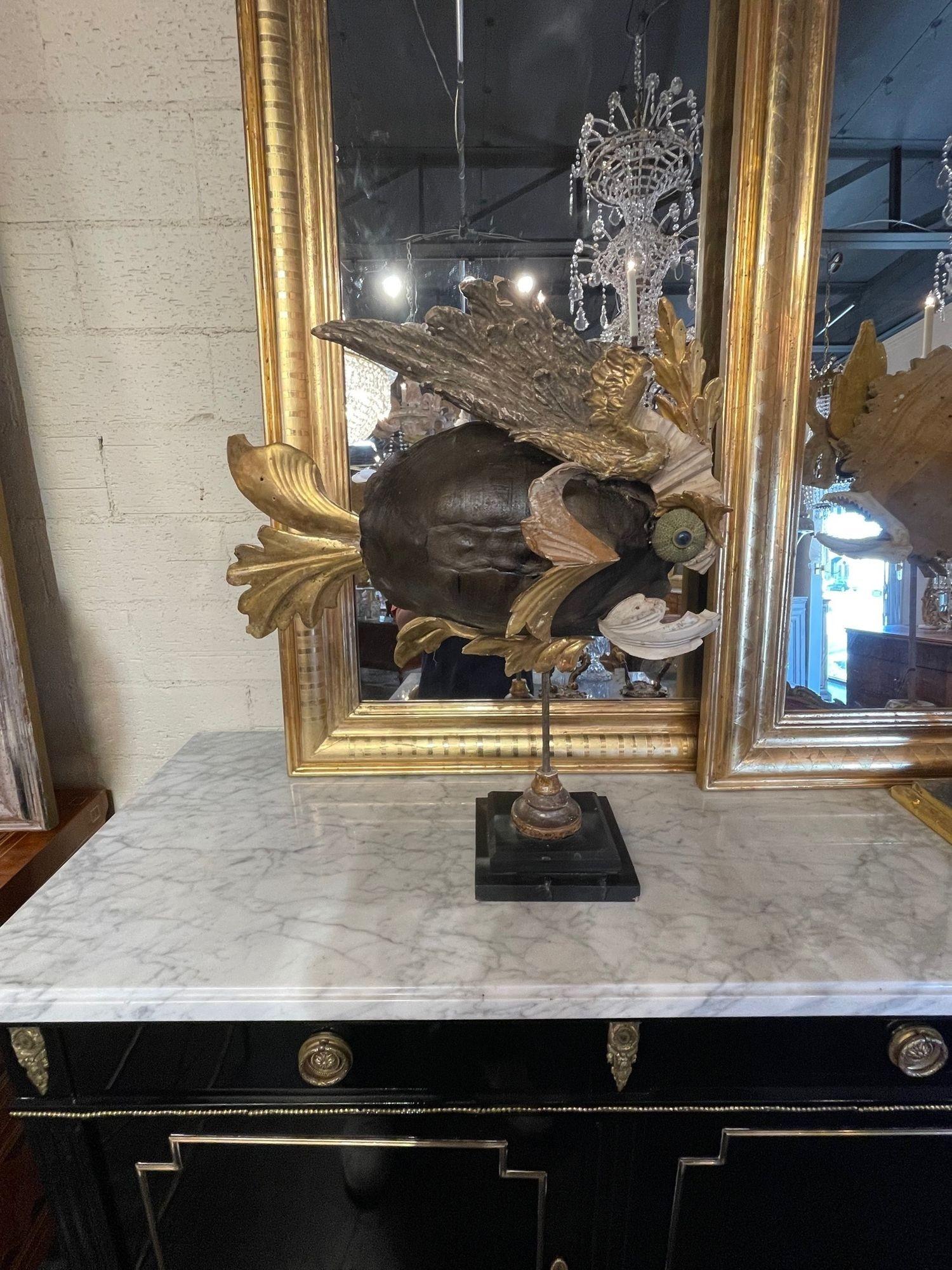 Unique 18th century giltwood element fish sculpture. This piece includes antique fragments along with a tortoise shell and sea shells. A real conversation piece.