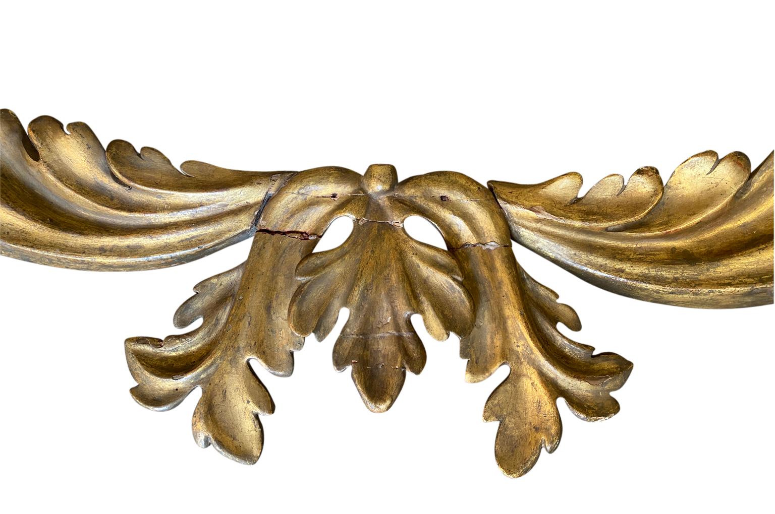 A very lovely 18th century giltwood pediment from Venice, Italy. Wonderful patina. Beautiful used as a window treatment or incorporated into a headboard.