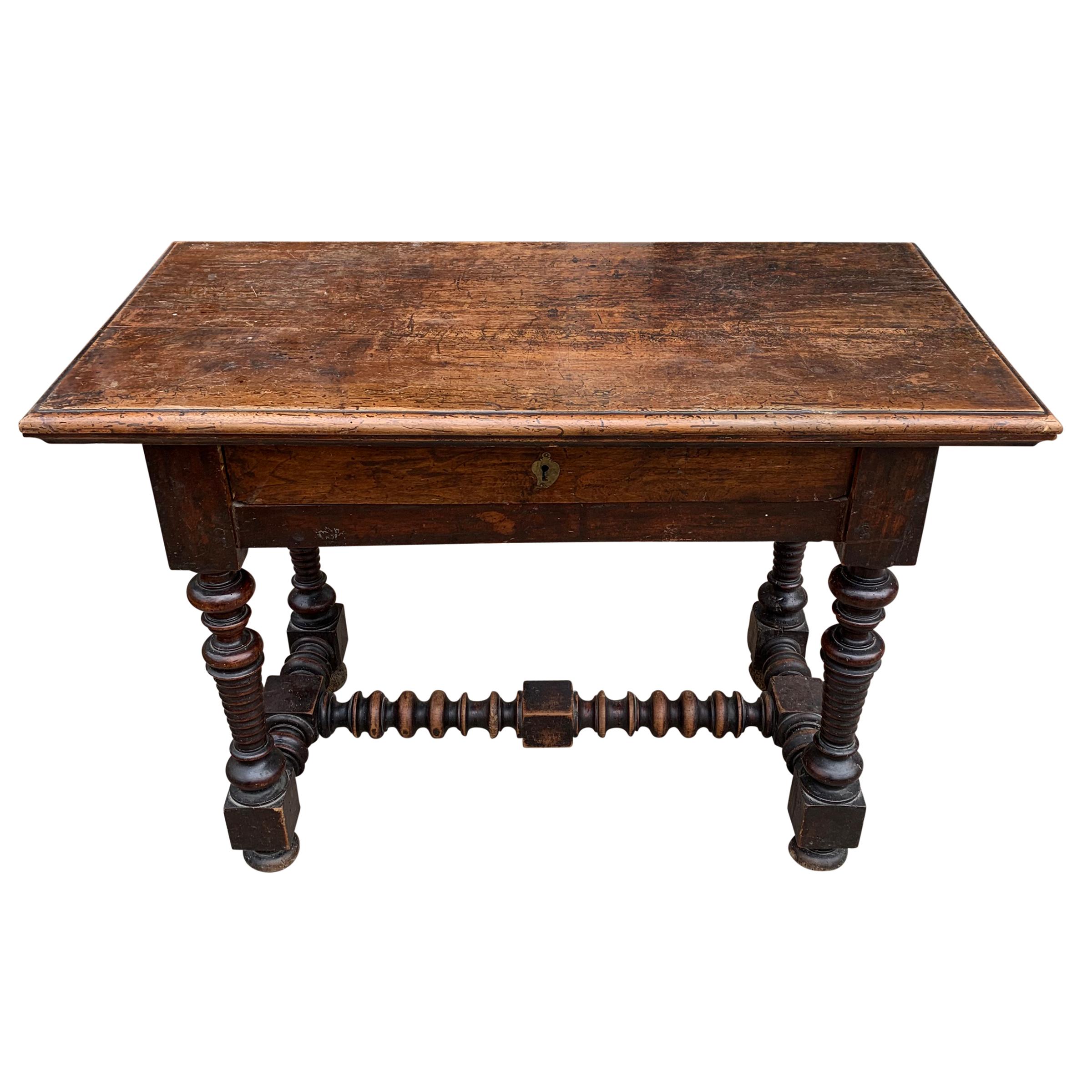 An incredible 18th century Italian hall table with elaborate exaggerated turned legs and stretchers, one drawer, a wonderful patina, and lots of personality! Lock on drawer is missing.