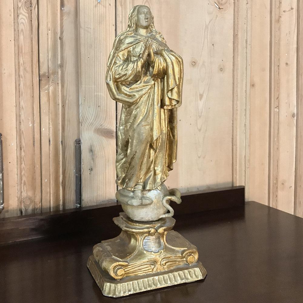 18th century Italian hand carved and painted wood Madonna statue depicts the virgin Mary in contemplative prayer, and poised in triumph over evil. Original gilt and hand painted finish has been preserved by methods first introduced by the ancient