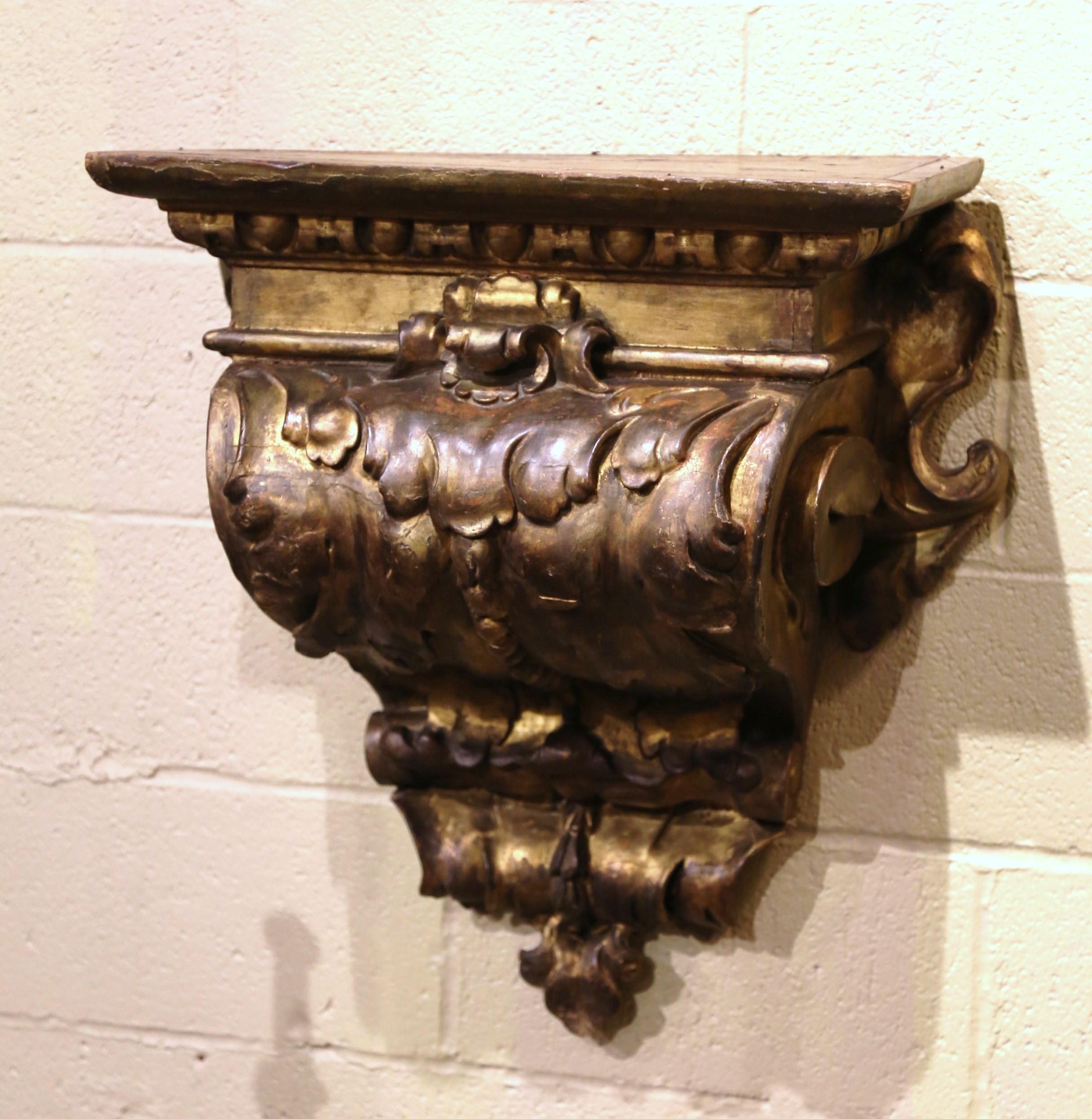 Display a bust or a vase on this elegant antique wall corbel; crafted in Italy, circa 1760, the large gilt wood wall bracket features hand carved scroll and acanthus leaf motifs throughout. The tall shelf console is in excellent condition