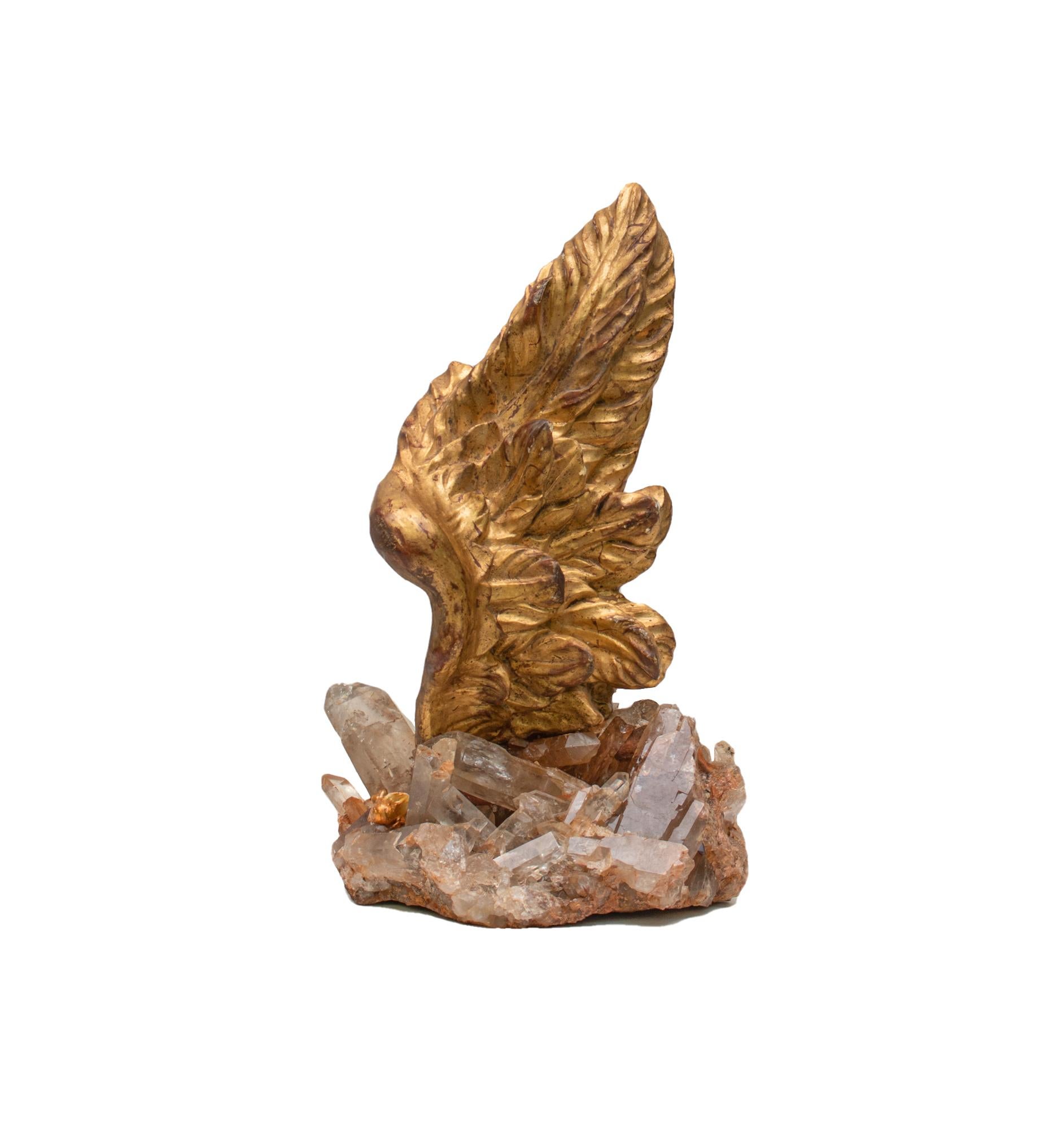 18th century Italian hand-carved gold leaf angel wing on a smoky quartz cluster.

The hand-carved gold leaf angel wing is originally from a church in Liguria. This piece is particularly rare and exquisite due to its unique shape and size. The depth