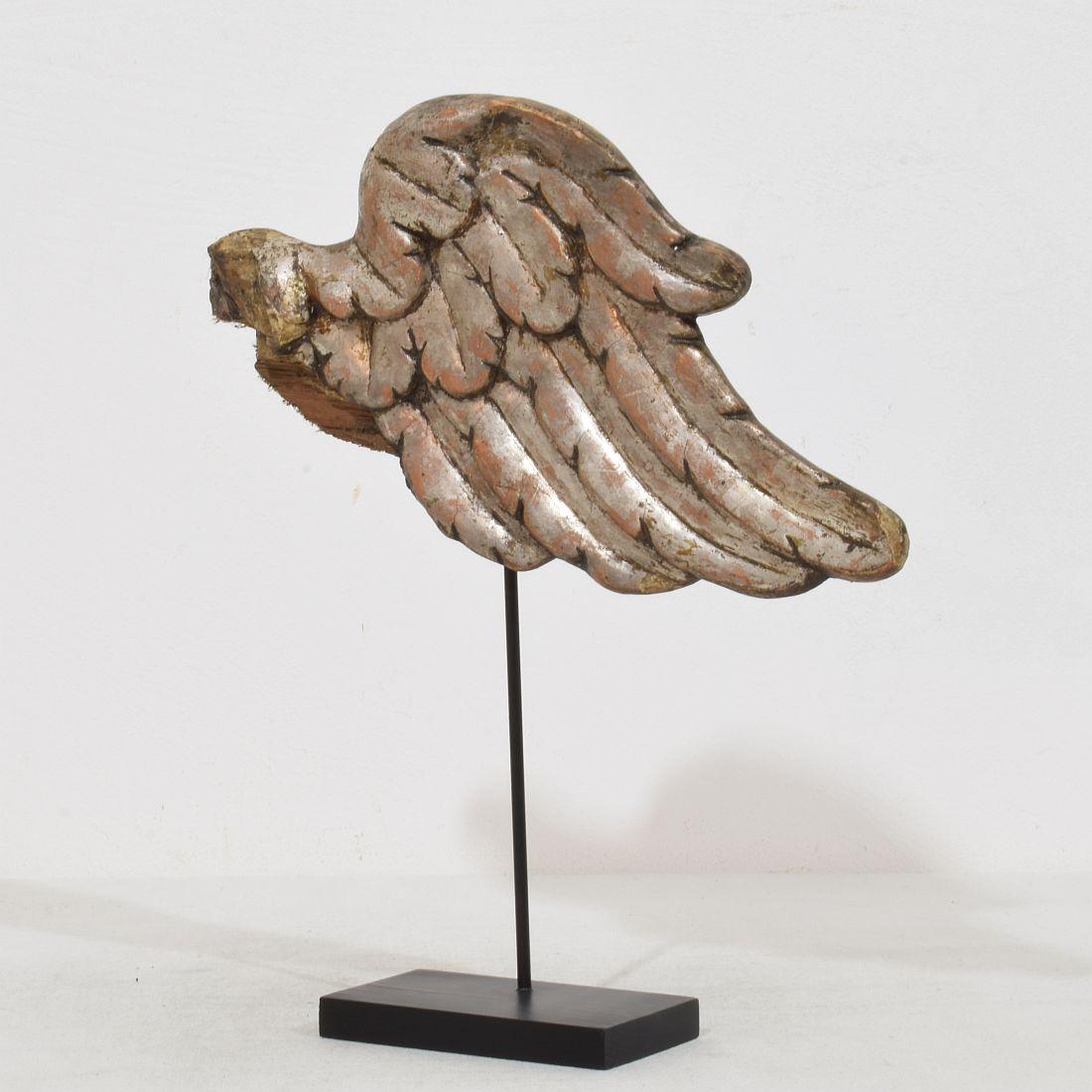 Beautiful Silvered Baroque angel-wing. Rare and very decorative item placed on a wooden base, Italy, circa 1750. Weathered. Measurement is inclusive the wooden base.
H:27,5cm  W:24cm D:5,5cm 
