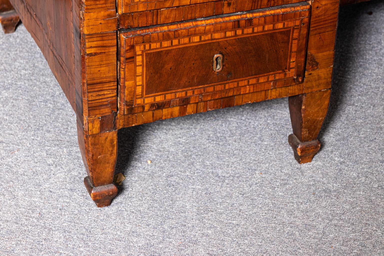Italian inlaid partner's desk with nine working inlaid drawers and further inlay throughout, circa 18th century. The piece also features walnut veneer and soft wood. Please note of further wear consistent with age including some veneer repair,