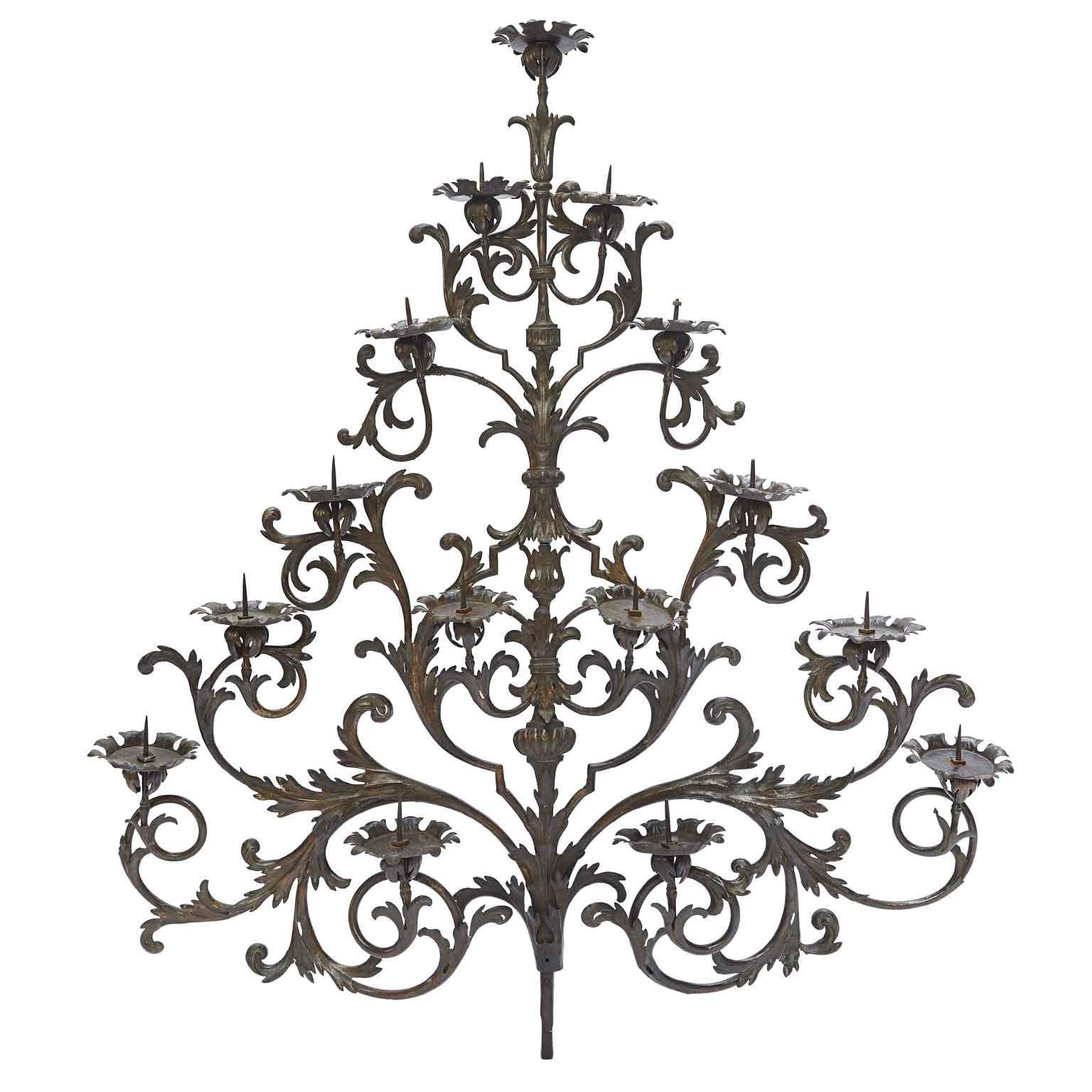 18th Century Italian Wrough Iron Sconce Monumental Fifteen-armed Candelabra with a pyramidal hand-made iron frame decorated with scrolling, curling embossed motivs. This large size unique artwork is a 18th century Italian iron candlestick sconce