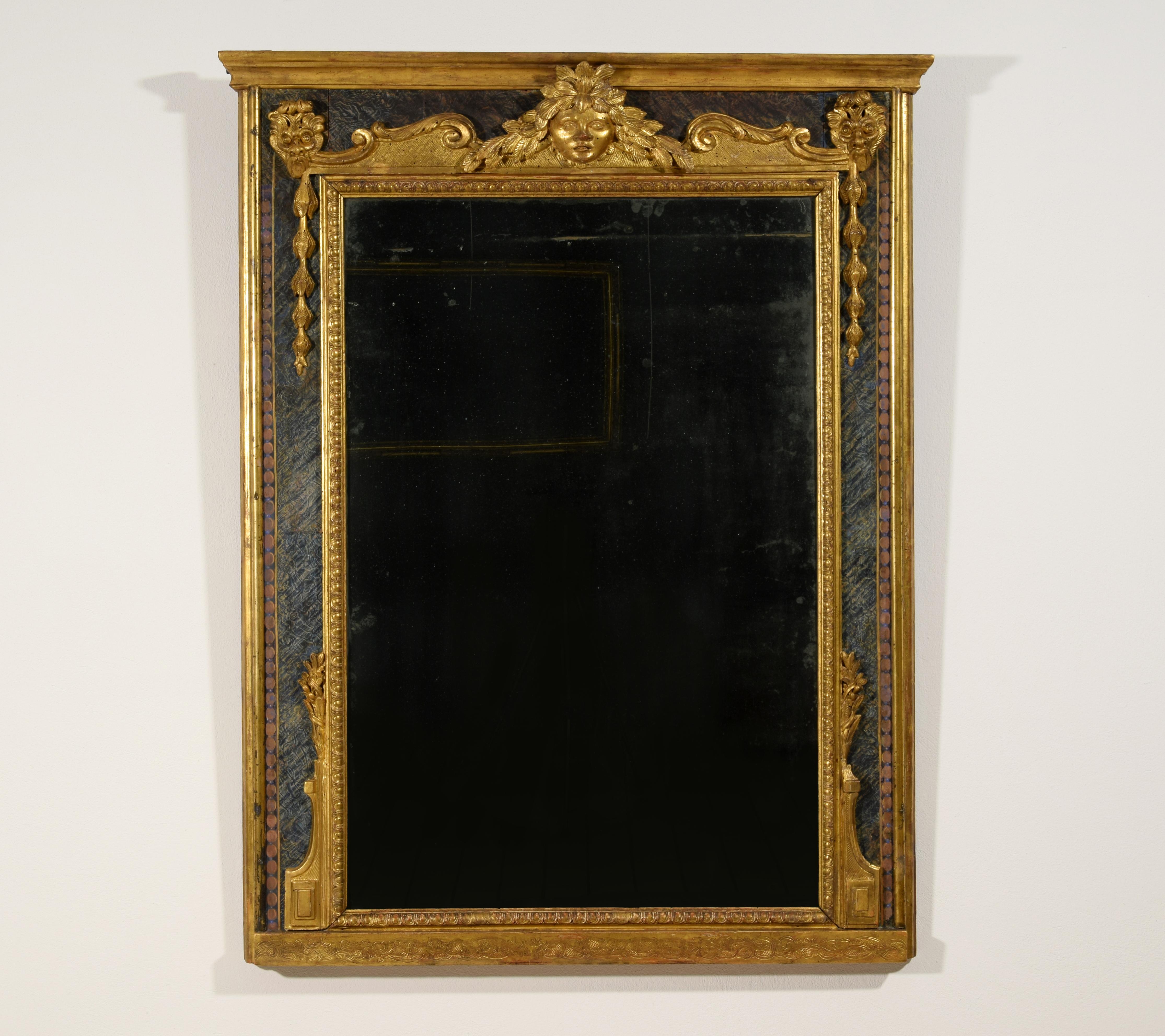 18th century, Italian Louis XIV carved giltwood mirror
The baroque mirror, made in Italy in the first half of the 18th century, has a rectangular frame in carved and gilded wood. The inner frame that surrounds the mirror is carved with palmette
