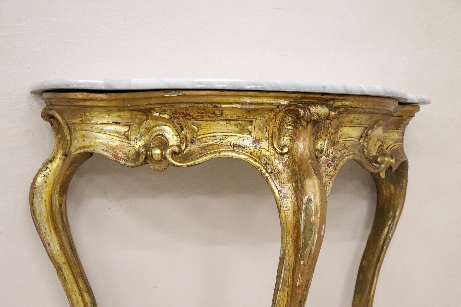 Beautiful antique Luis XV console table, 1750s. The console is made of solid carved and gilded wood. Precious Italian gray marble. Perfect to be placed even in small rooms or representative entrances. Some signs of the passage of time in gold.