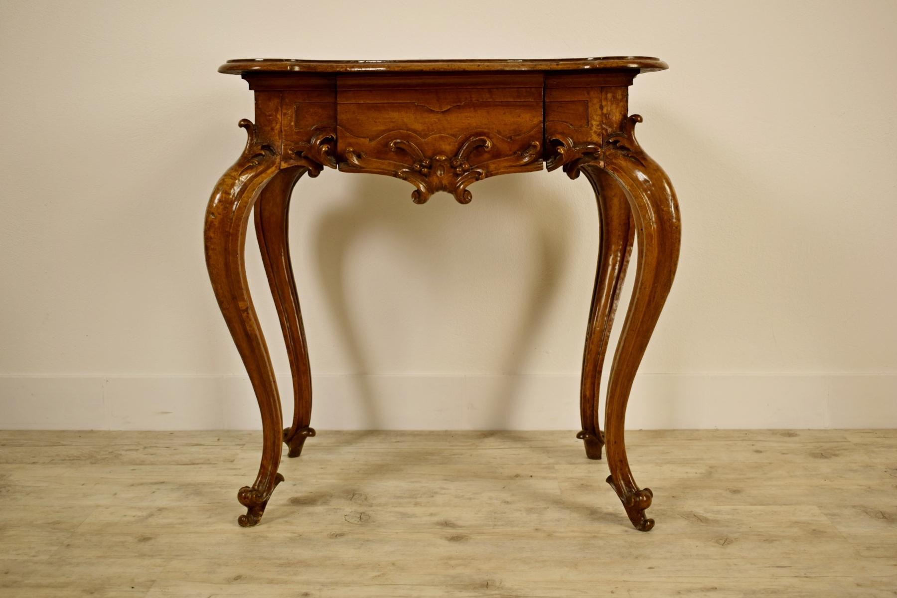 18th century, Italian Louis XV solid walnut wood console table

This coffee table was made in Piedmont, in Italy, around the middle of the eighteenth century, Louis XV, in finely carved solid walnut. The top has a straight side and three wavy,