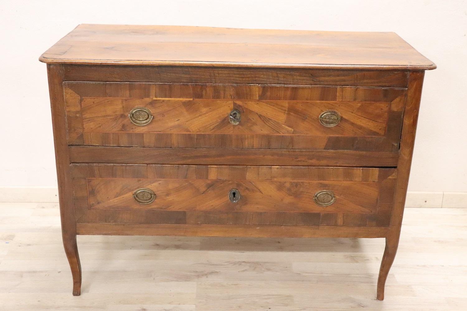 Important and rare antique Italian of the period Louis XV chest of drawers, 1750. On the front two useful drawers. Featuring a beautiful shade of walnut with decoration on the front of the drawers, slender and wavy legs.  Due to its small size, it