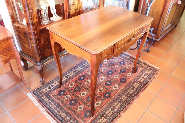 Elegant antique Italian Louis XV writing desk. The desk is made of walnut wood. beautiful wavy line with slender but solid legs. Plenty of space for your writing needs and two comfortable large drawers on the front. The back is rough because this