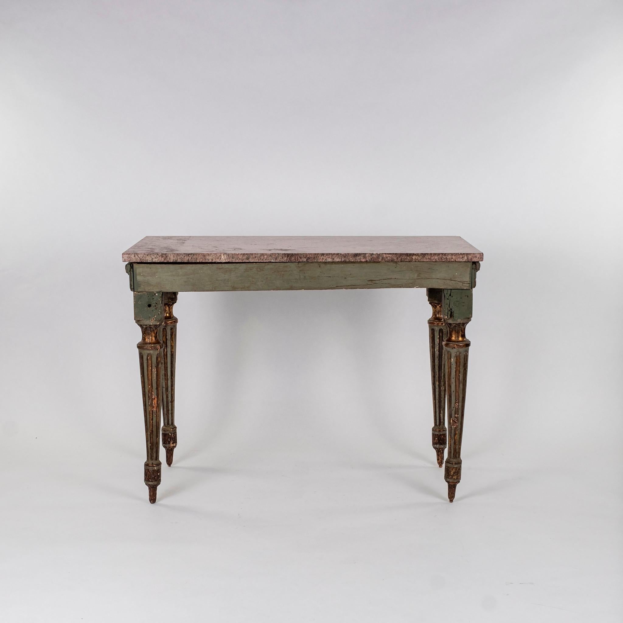 Period 18th century Italian Louis XVI console table with rouge marble top. Console is raised by fluted tapered legs and decorated with ribbons and rosettes.