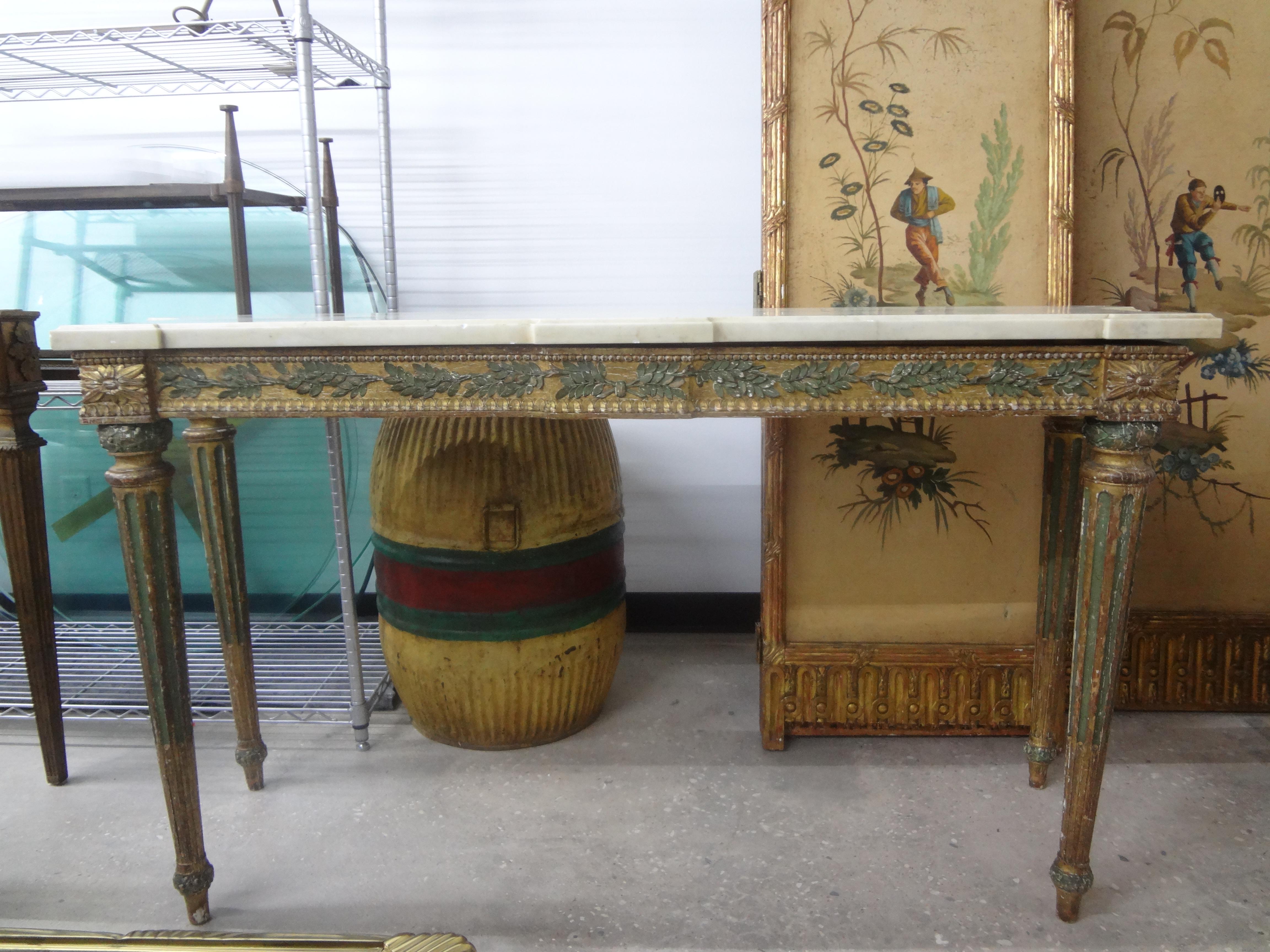 18th century Italian XVI painted and parcel gilt console table with marble top. This stunning large 18th century Neoclassical style Italian console table is freestanding with a beautiful design on the apron and fluted legs possessing the original