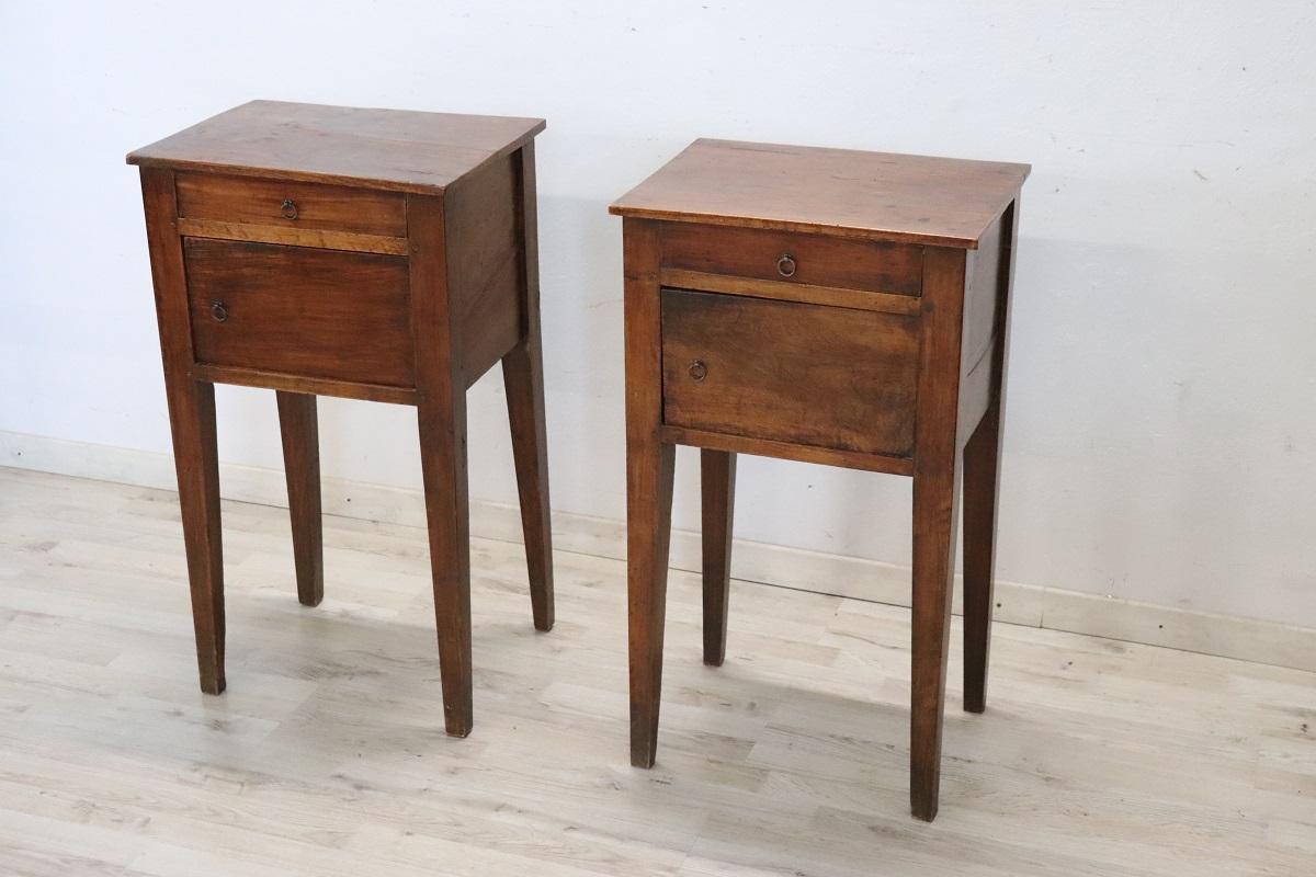 Lovely Italian set of two nightstands of the period Louis XVI, 18th century in solid walnut wood. The nightstands very linear and rustic. On the front one-drawer and one-door. A very simple line also perfect for a modern bedroom.