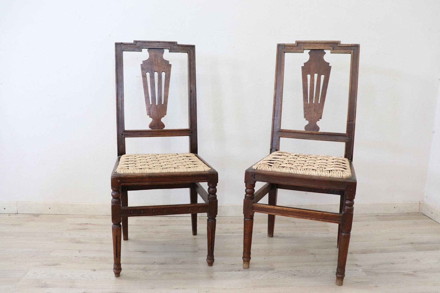 Pair of refined 18th century authentic Italian Louis XVI walnut wood chairs. The legs are very elegant straight. The seat is wide and comfortable. The seat in plaited woven straw. The chairs are used have small signs of wear. Please look good all