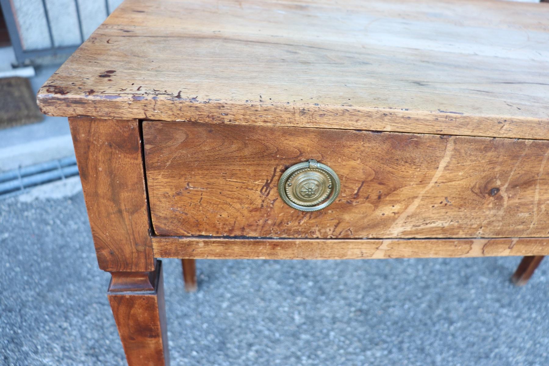 Elegant antique Italian Louis XVI writing desk. The desk is made of walnut wood. Simple essential line with solid straight legs. Plenty of space for your writing needs and one comfortable large drawers on the front. 
The antique desk has been used