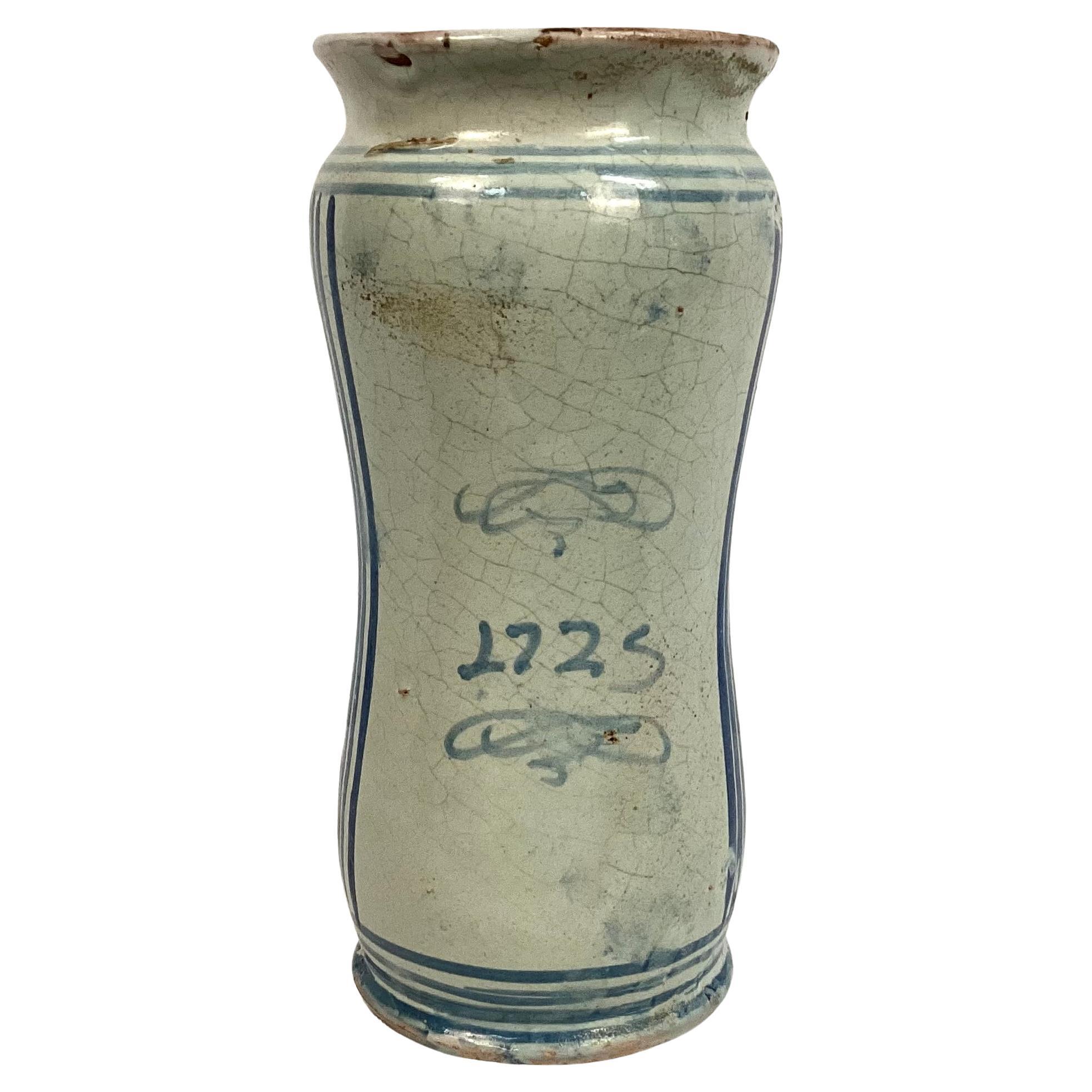 18th Century Italian Majolica Albarello Pharmacy Jar. Jar is in a cylindrical shape with flared rim and foot. Jar features blue and white pattern with the word 