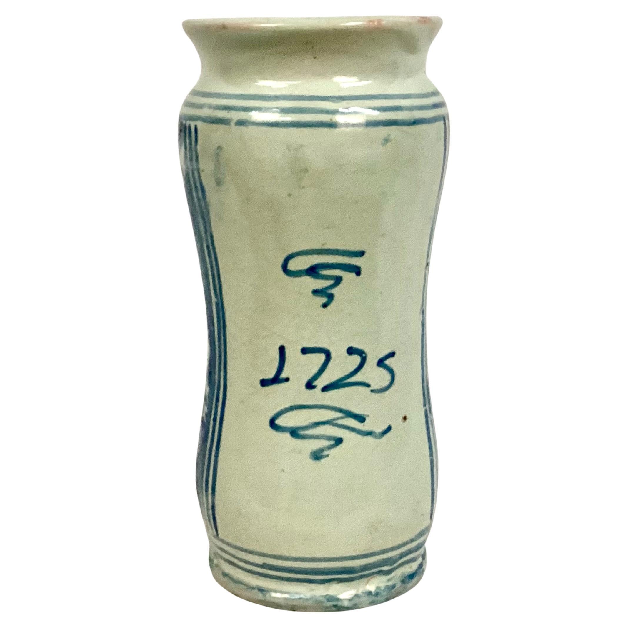 18th Century Italian Majolica Albarello Pharmacy Jar. Jar is in a cylindrical shape with flared rim and foot. Jar features blue and white pattern with the word 