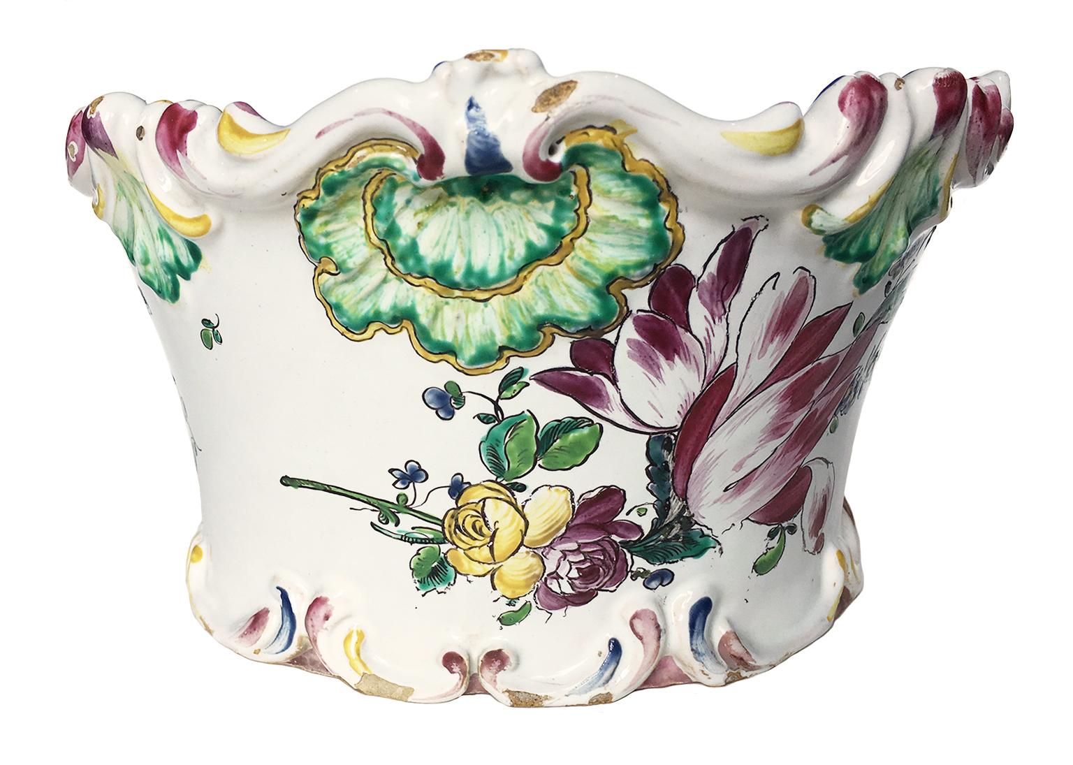 Maiolica flower pot “a mezzaluna” decorated with tulip

Pasquale Rubati Factory
Milan, circa 1770. 
Measures: 4.7 in x 4.7 in x 8.6 in 
12 cm x 12 cm x 22 cm
lb 1.76 (kg 0.8)
State of conservation: intact with slight chipping due to use in relief