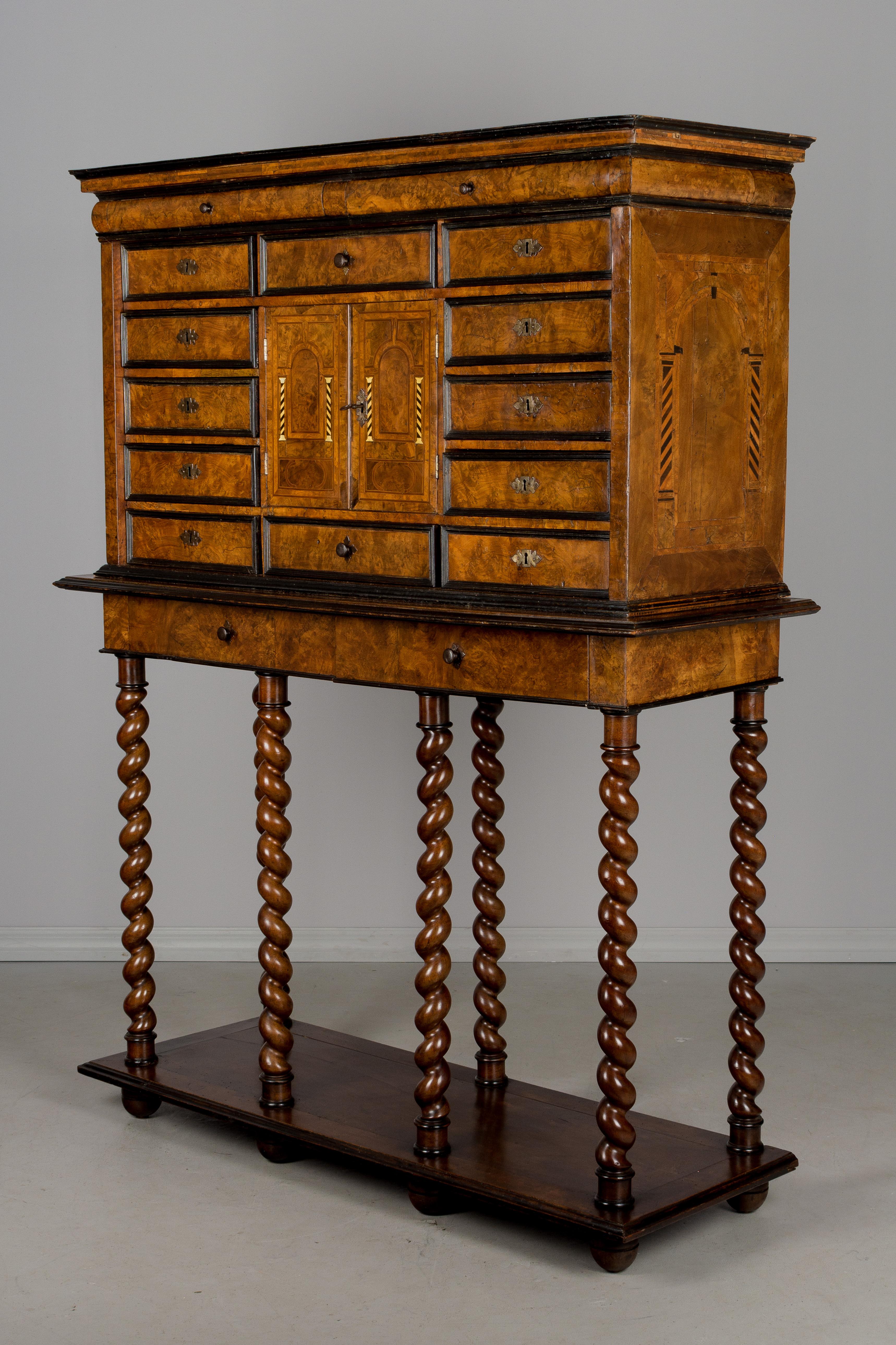 An magnificent 18th century Italian marquetry vargueno, or chest on a stand. The chest is made of burl of walnut veneer on pine with various wood inlay and ebonized trim and has 14 drawers, 4 with small iron knobs and 10 with locks. Two small