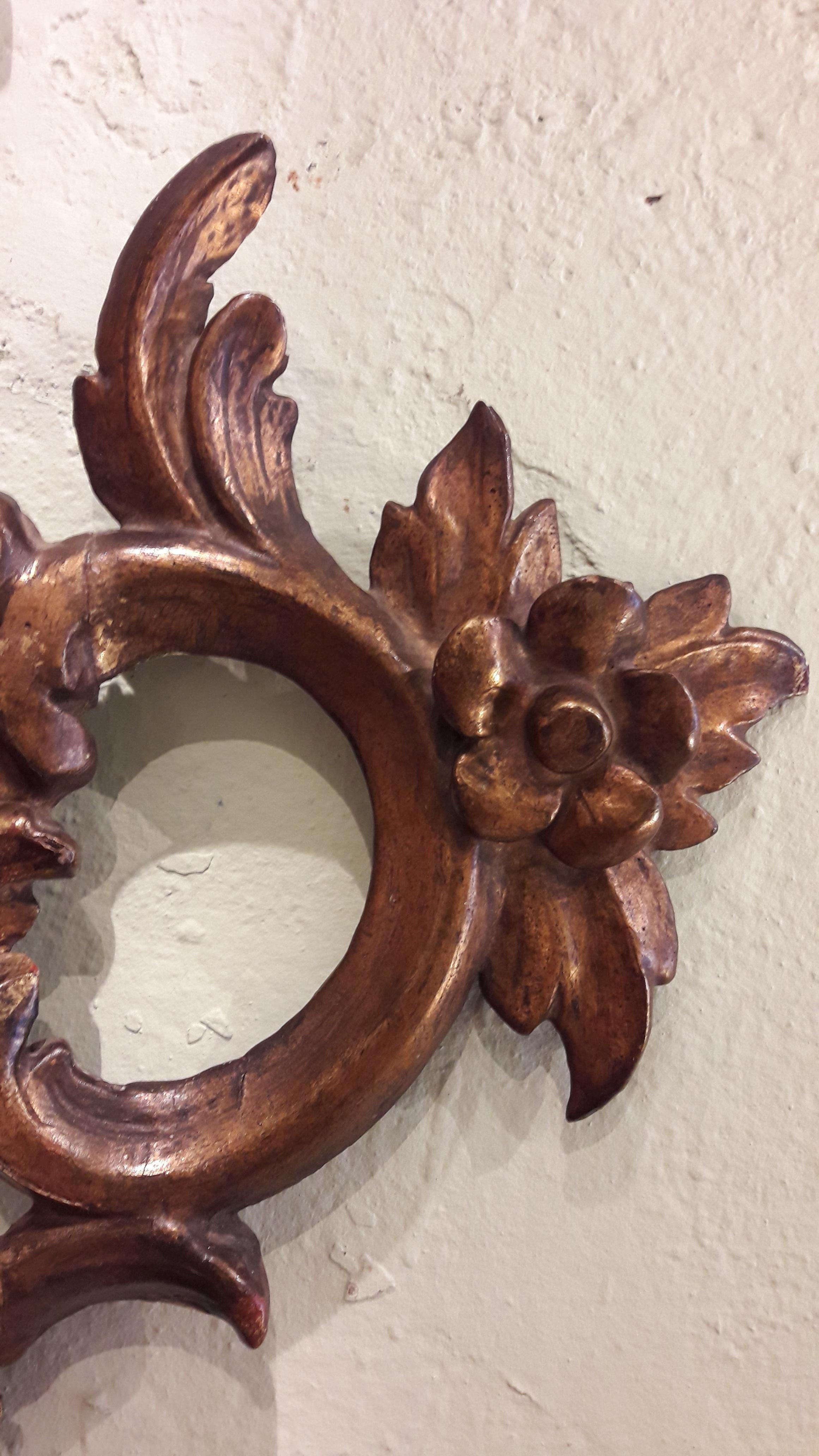 Very decorative wooden carved and gilded frame. Italian Rococo. The mirror has been replaced.