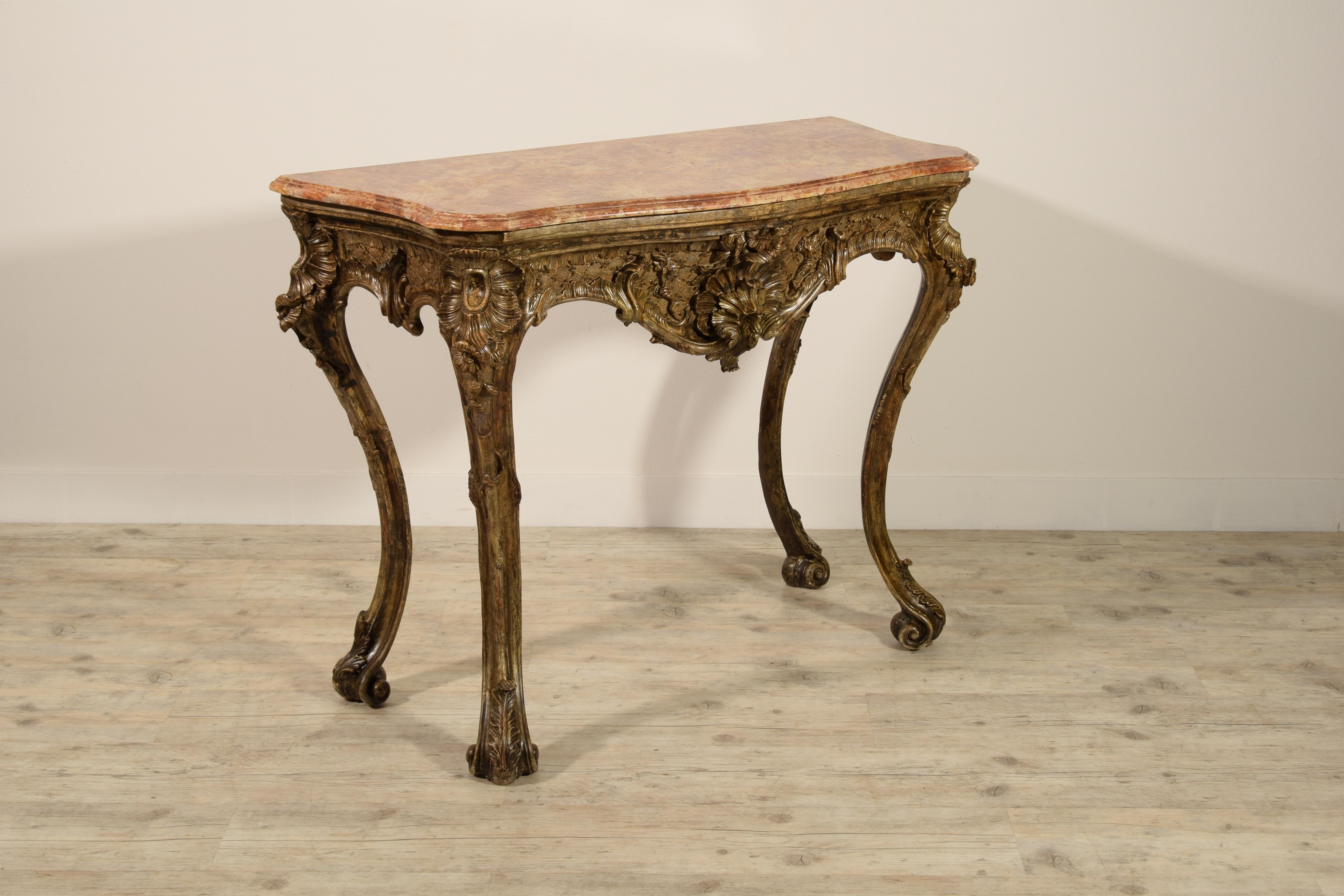 18th century, Italian Naples baroque carved wood console

This console made of richly carved and gilded with “Mecca” wood, is a characteristic example of the decorative repertoire widespread in Naples in baroque cabinet-making around the first