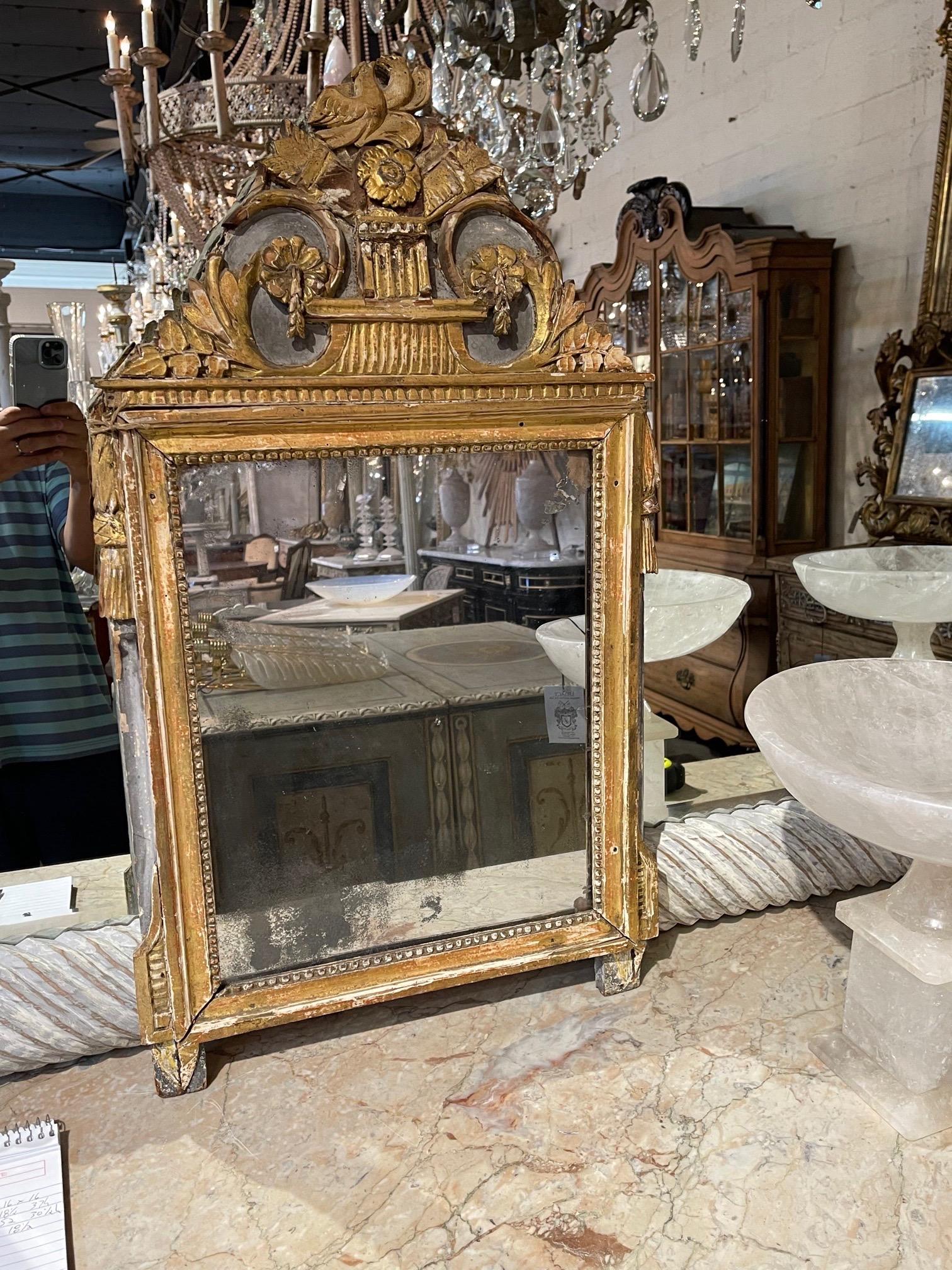 Beautiful 18th century Italian neo classical carved and parcel gilt mirror. Intricate carving at the top of the mirror including flowers and a bird. So pretty!!
