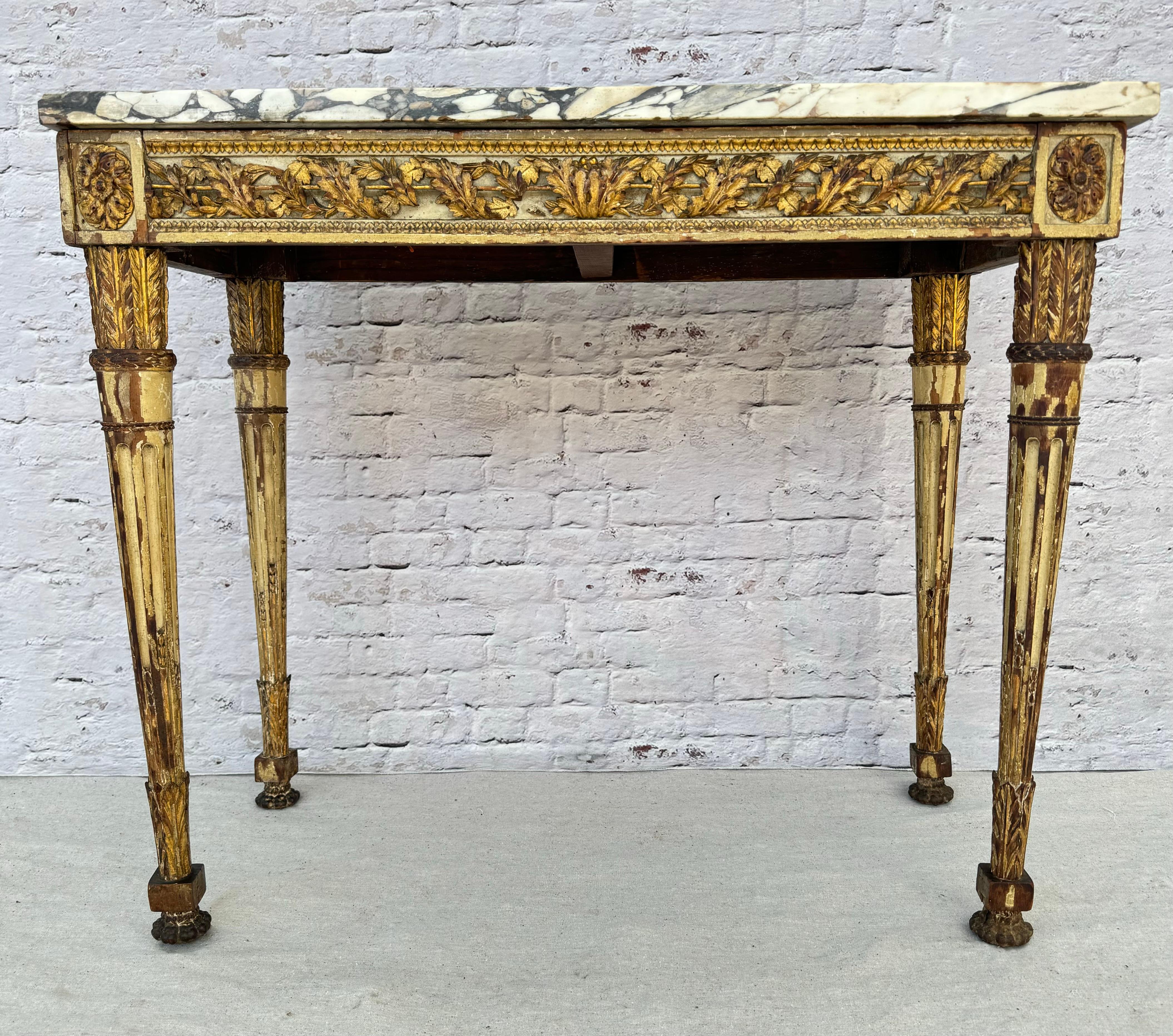 Impressive 18th century Italian neoclassical console table with original Breche marble top. Table features intricate carvings and scrollwork with parcel-gilt finish to enhance the decorative appeal. The marble top adds elegance and durability. Table