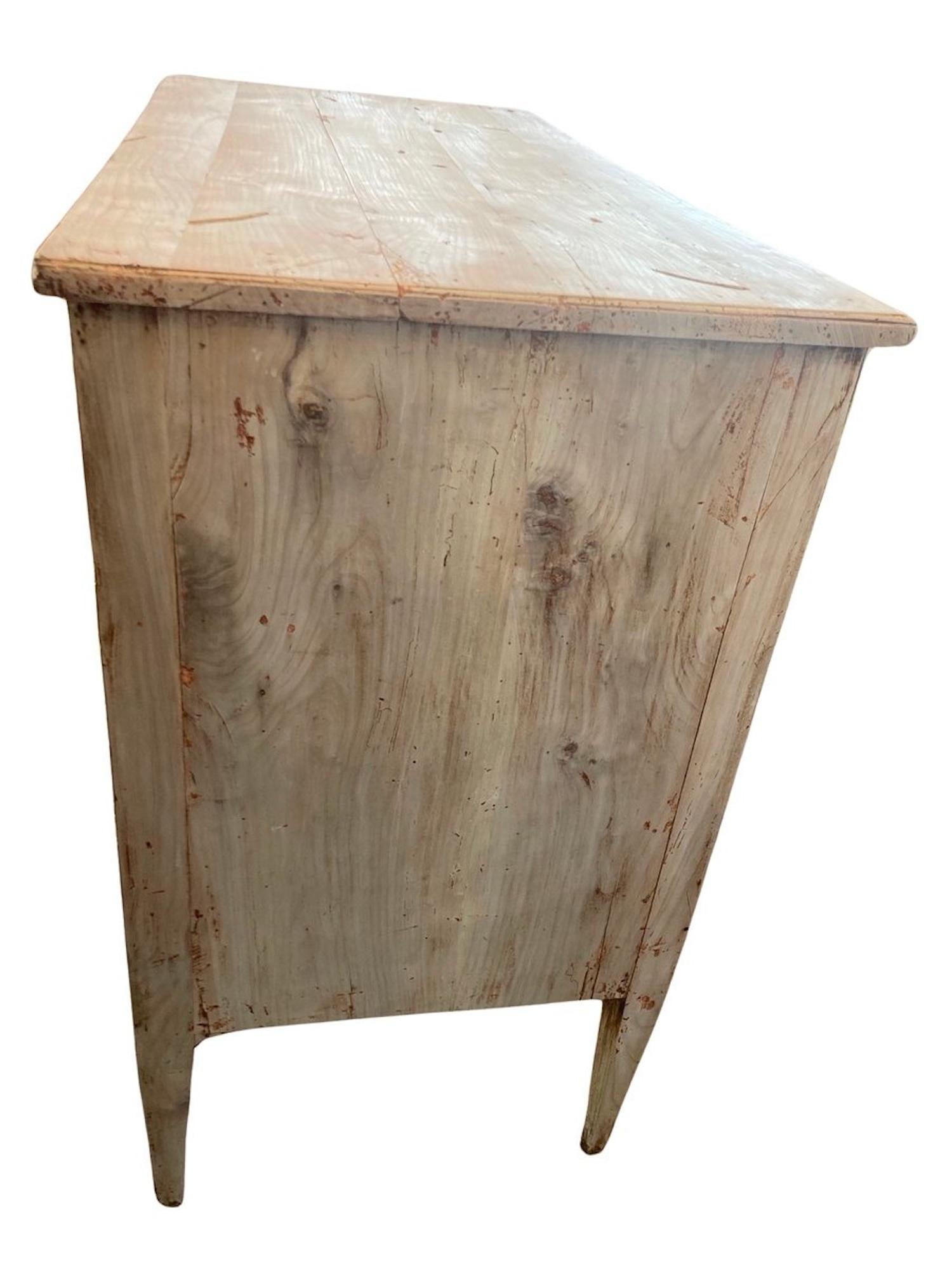 Bleached neoclassical chest of drawers hand-made in Italy using cherry as the primary and walnut burl for decoration. The commode features three overlay drawers, all showing beautiful hand-made dovetail joints and decorated with walnut crossbanded